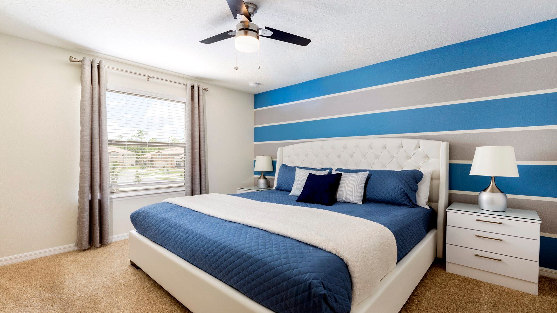 The master bedroom features a luxuriously large king bed with a crib.