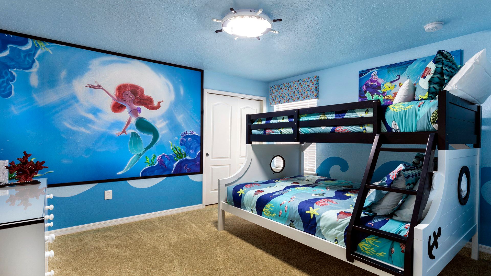 Magical mermaid-themed room with ocean-inspired bunk beds and colorful sea decor.