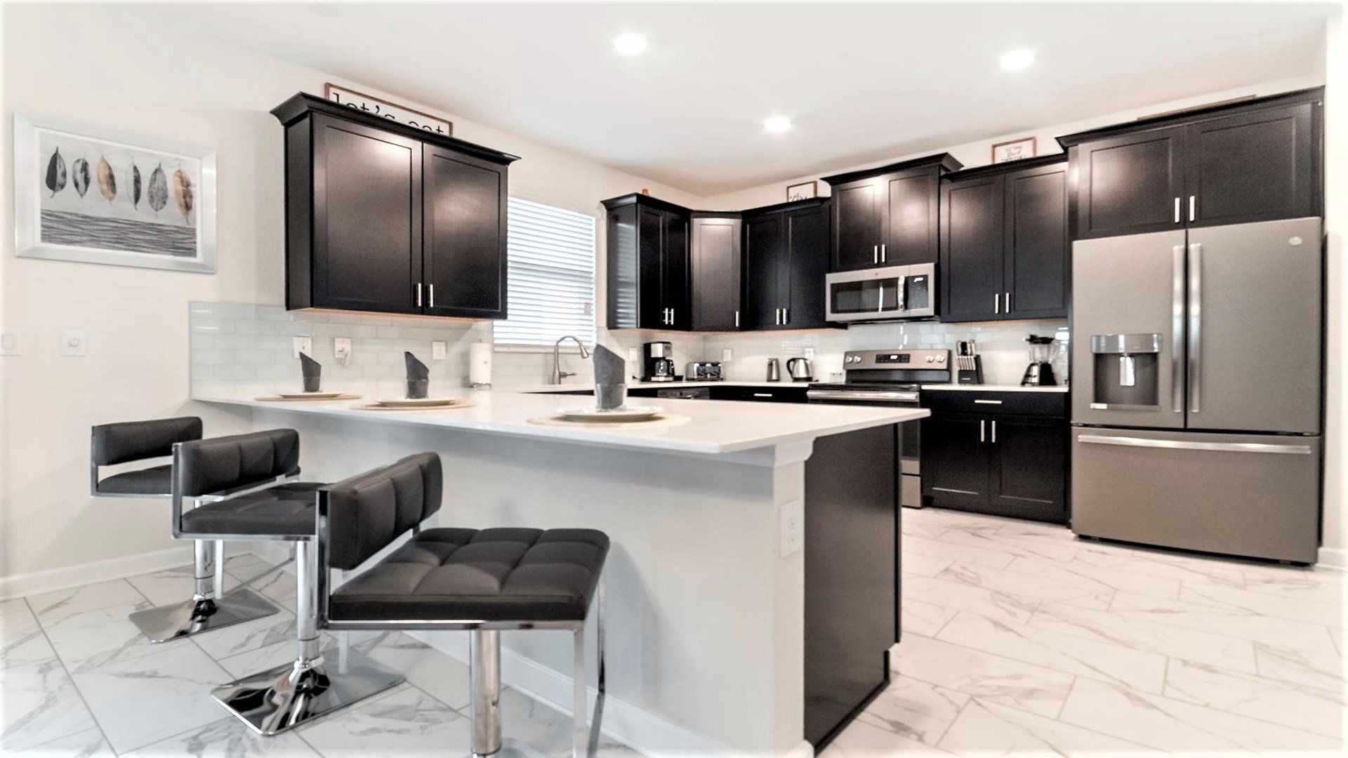 The kitchen is equipped with utensils, cookware, and dinnerware.