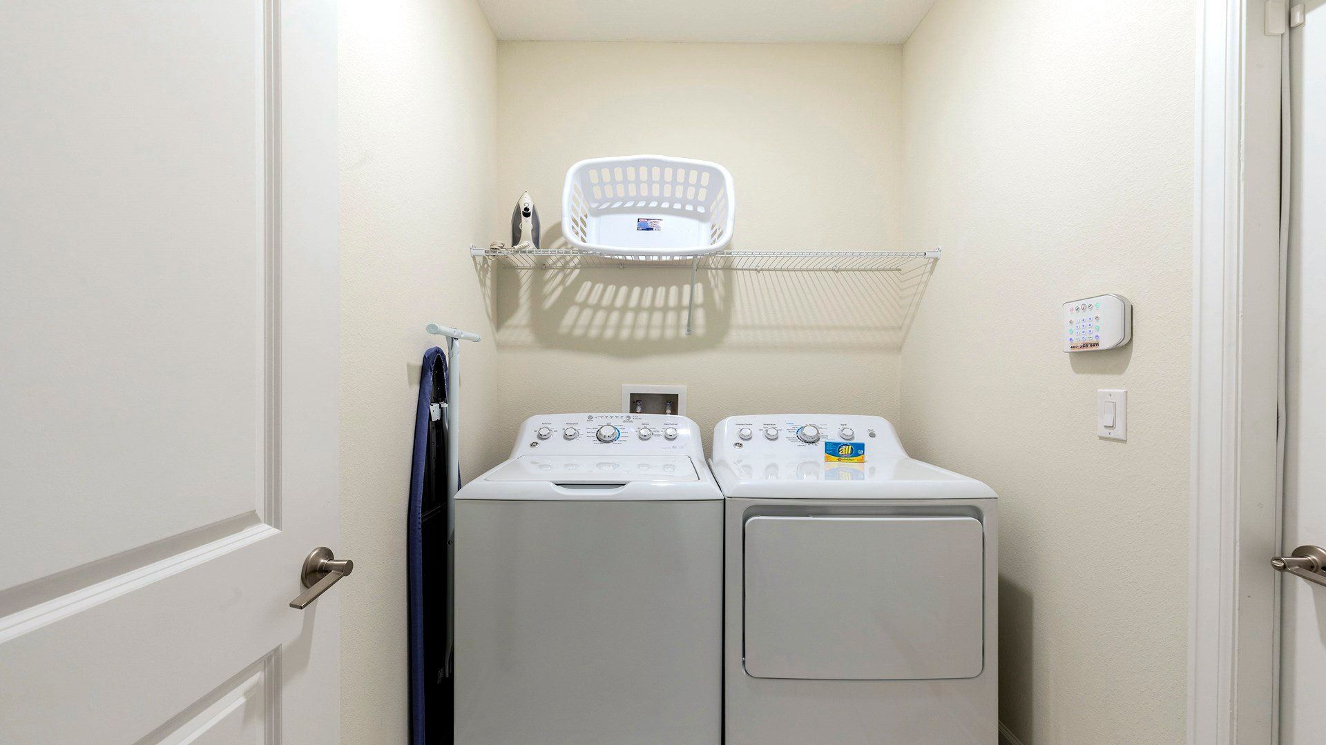 Convenient laundry room with washer, dryer, and essentials for easy cleaning.