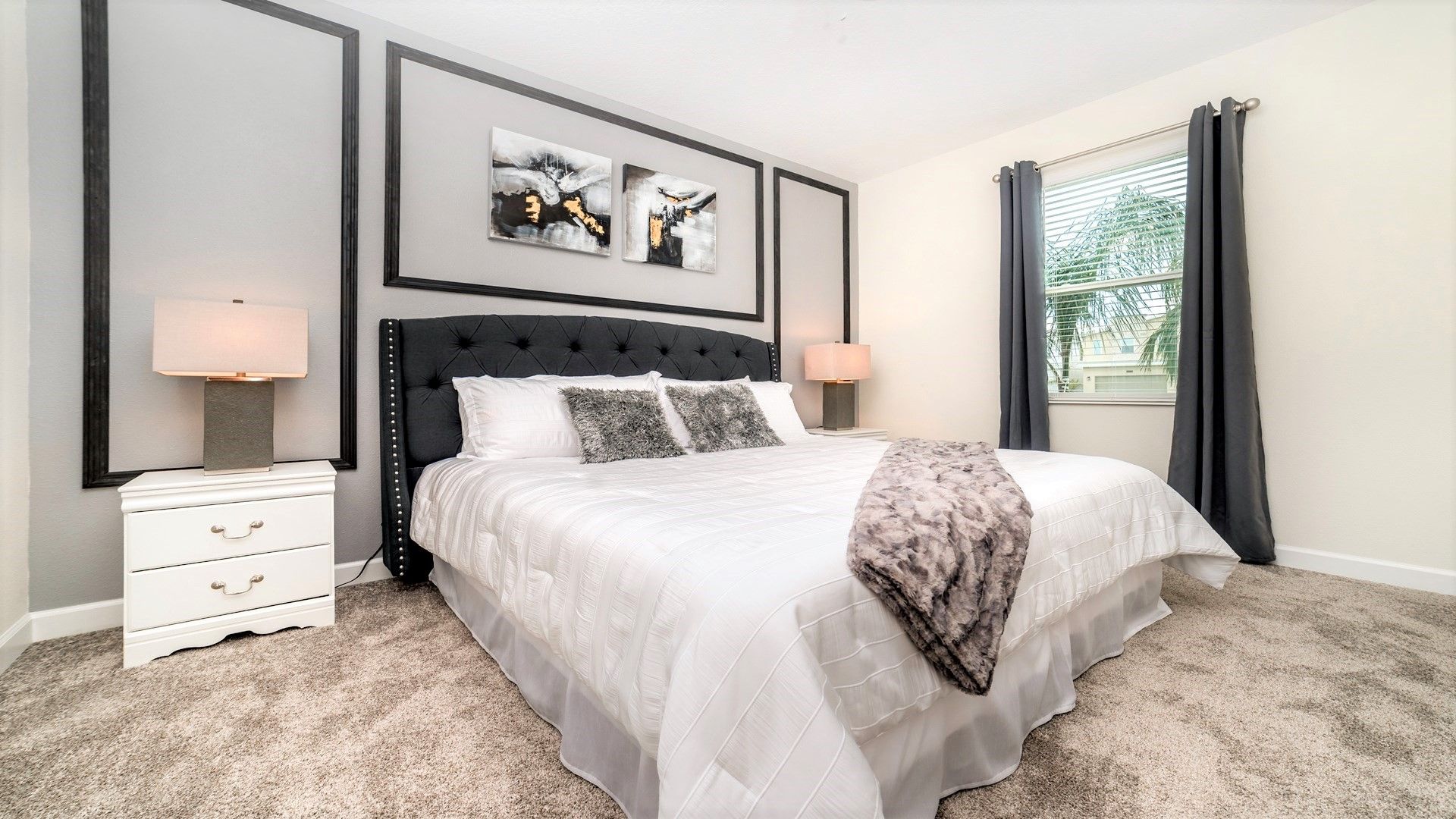 Modern bedroom with a plush king bed, chic decor, and soft tones!