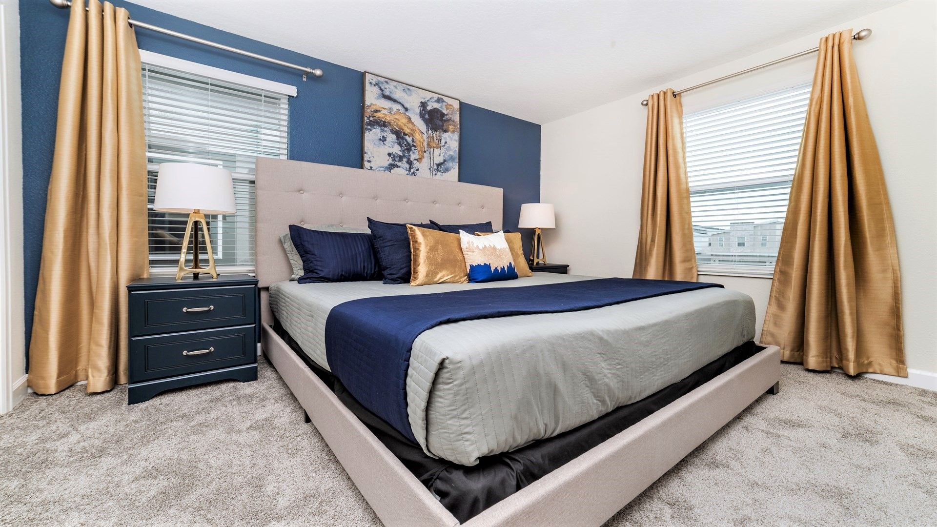 Elegant bedroom with navy accents, king bed, and cozy ambiance!