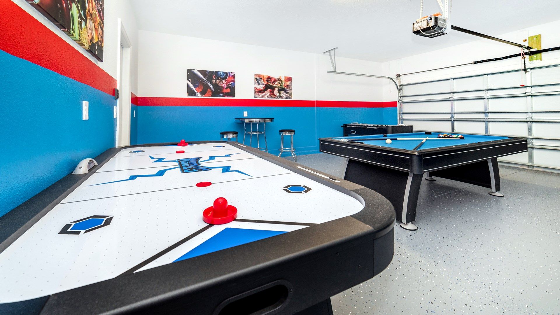 Vibrant game room with air hockey, pool table, and hero-themed fun!