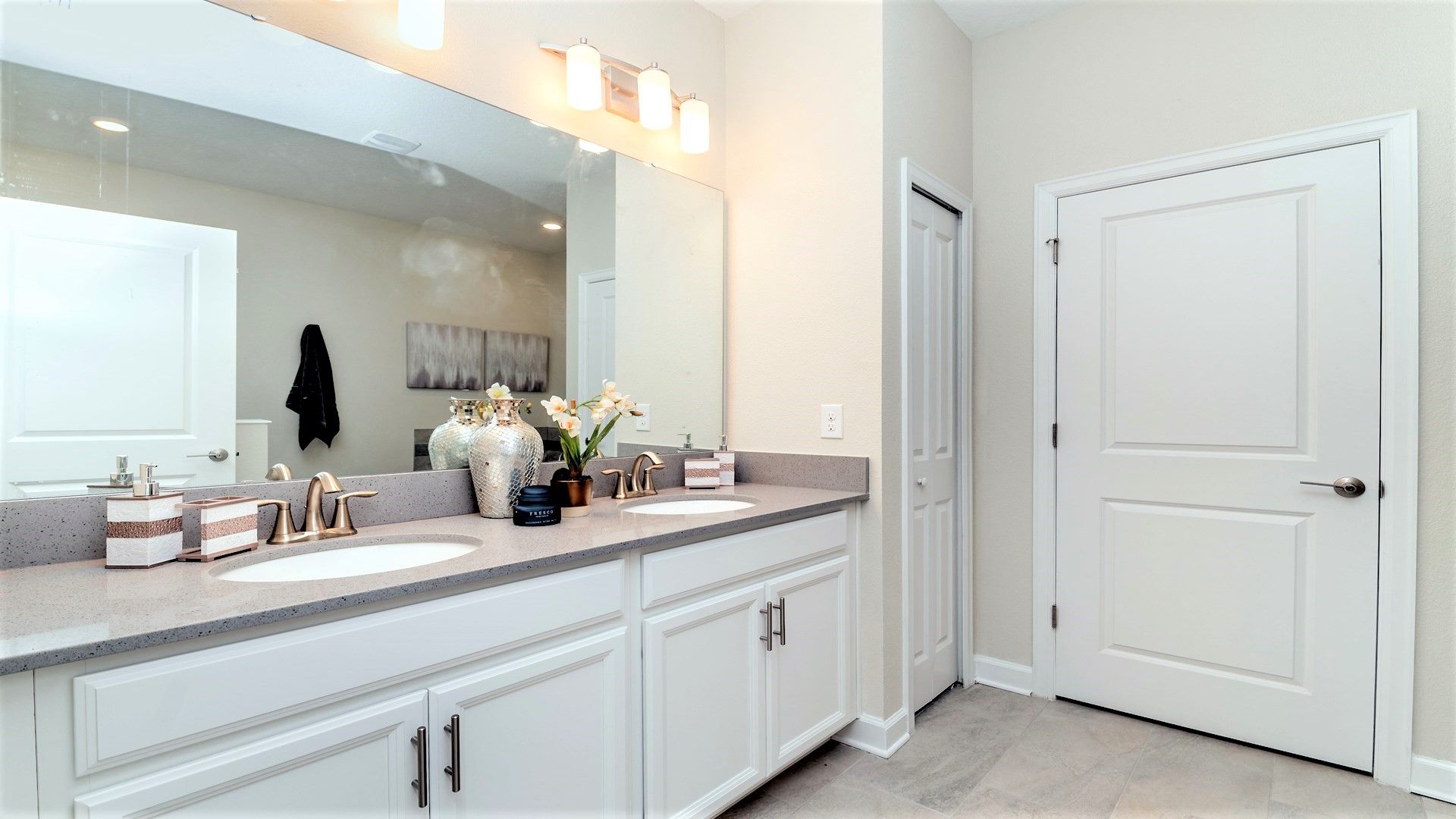 Bright bathroom with dual sinks, stylish decor, and ample storage!