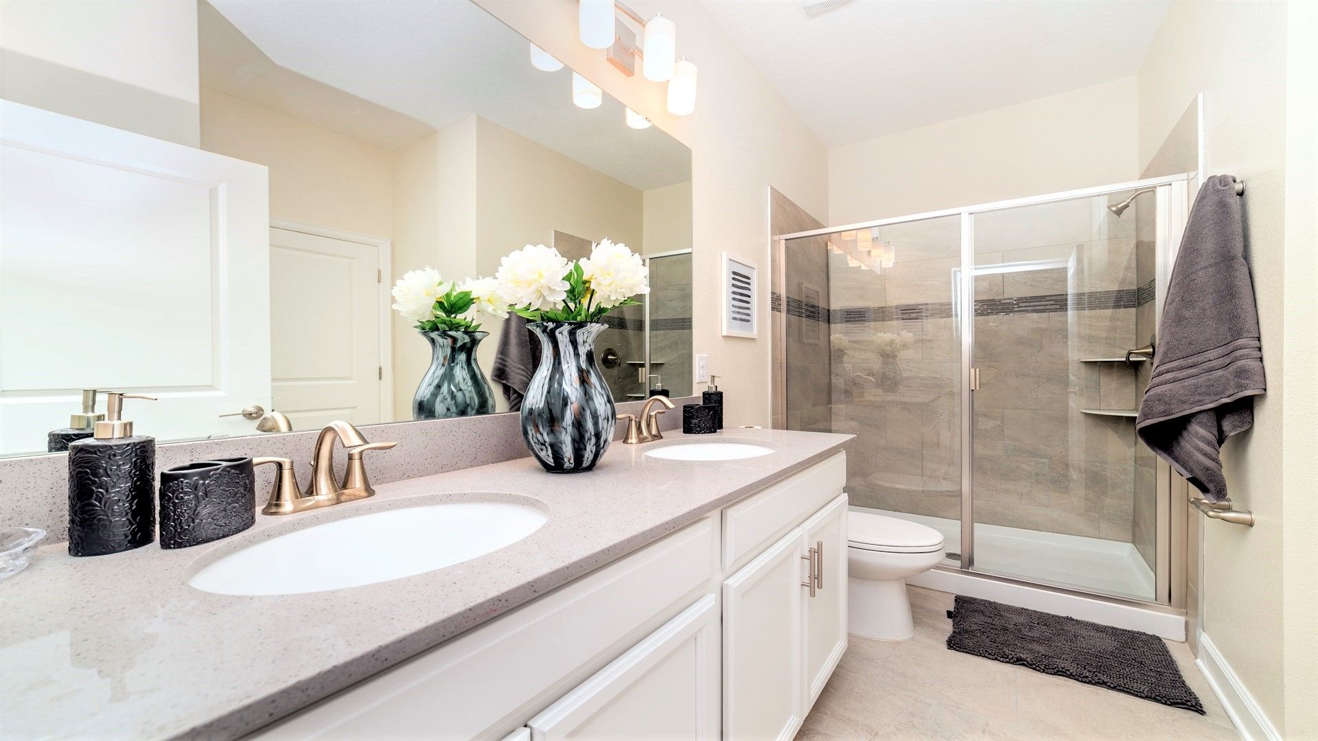 Elegant bathroom with dual sinks, modern finishes, and walk-in shower!