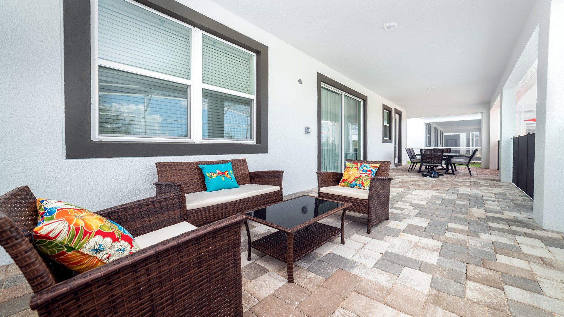 Cozy outdoor seating area with colorful cushions and modern charm!