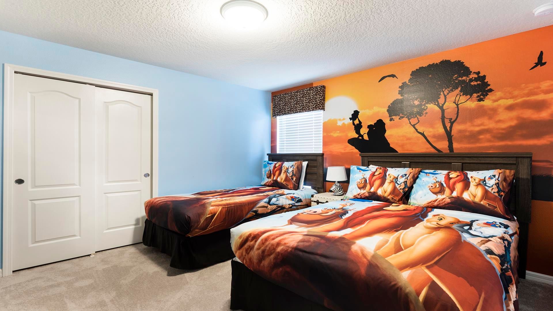 Safari-themed bedroom with vibrant decor and twin beds for kids!