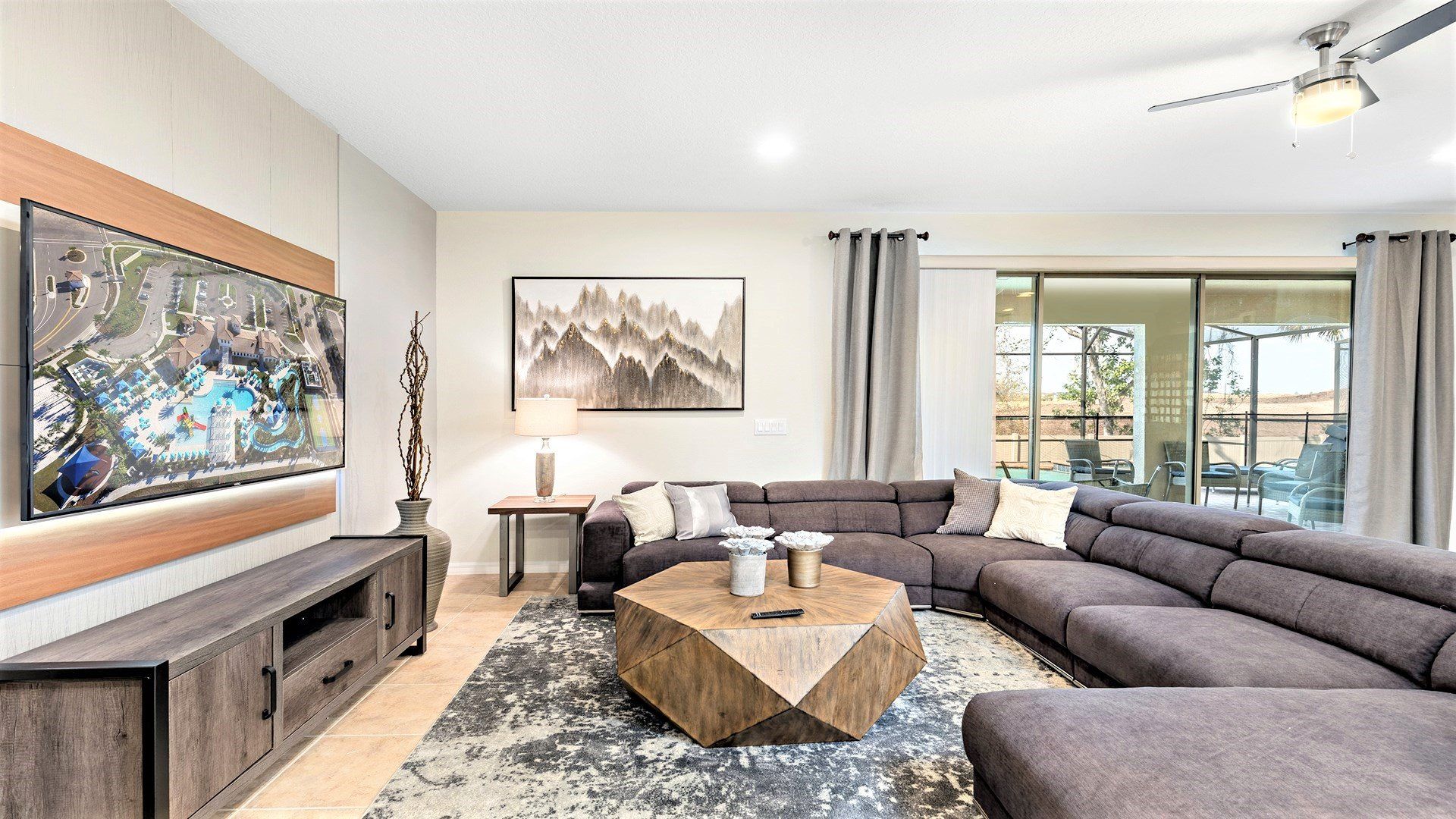 Modern living room with cozy sectional, smart TV & pool views!