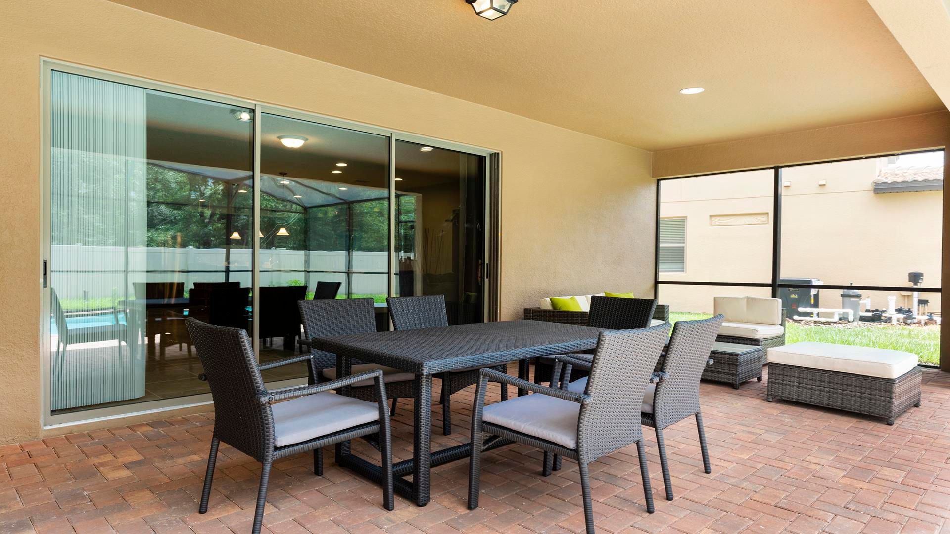 Spacious screened patio with dining table, lounge seating, and outdoor charm!