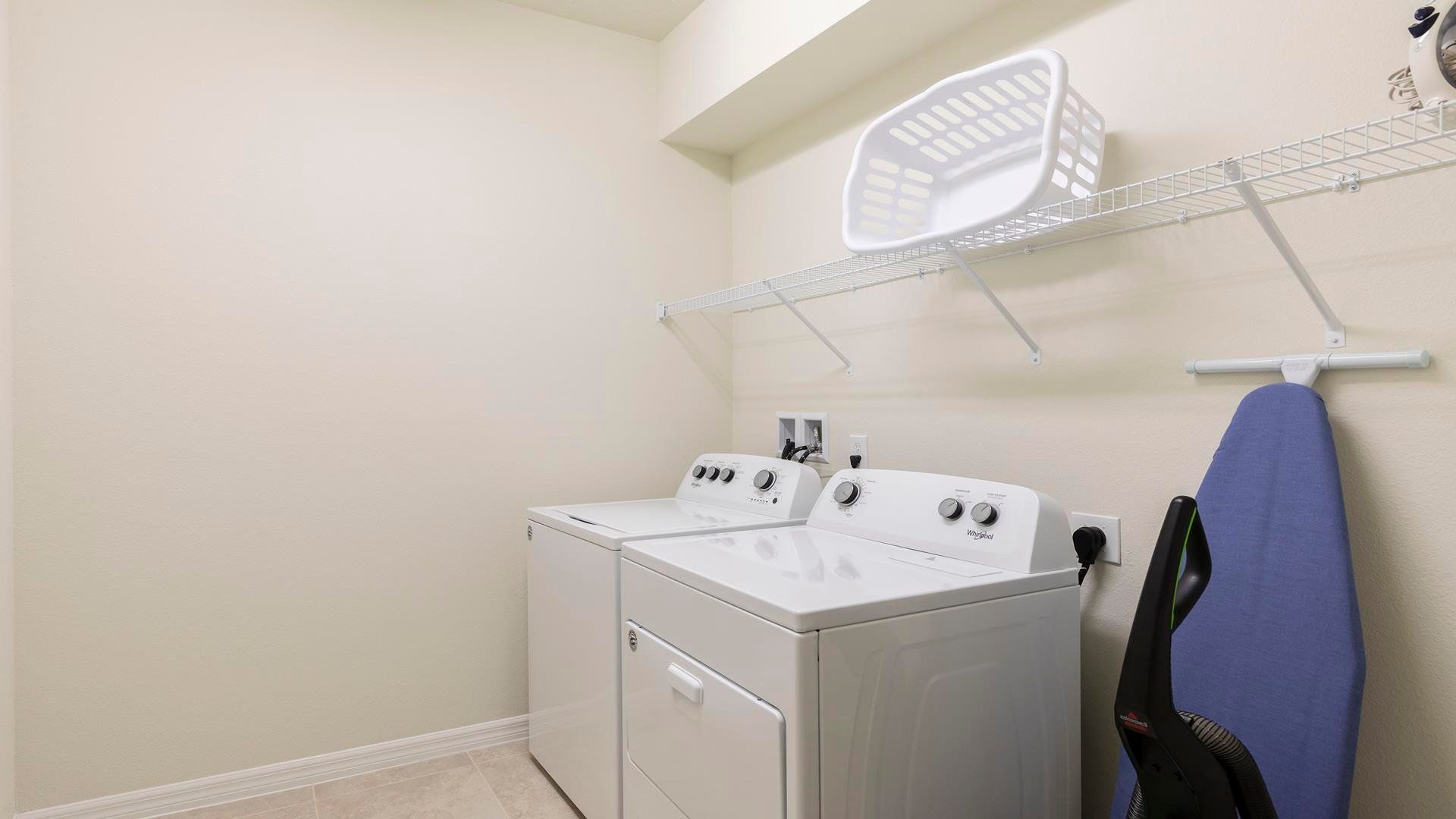 Convenient laundry room with washer, dryer, and ample storage space!