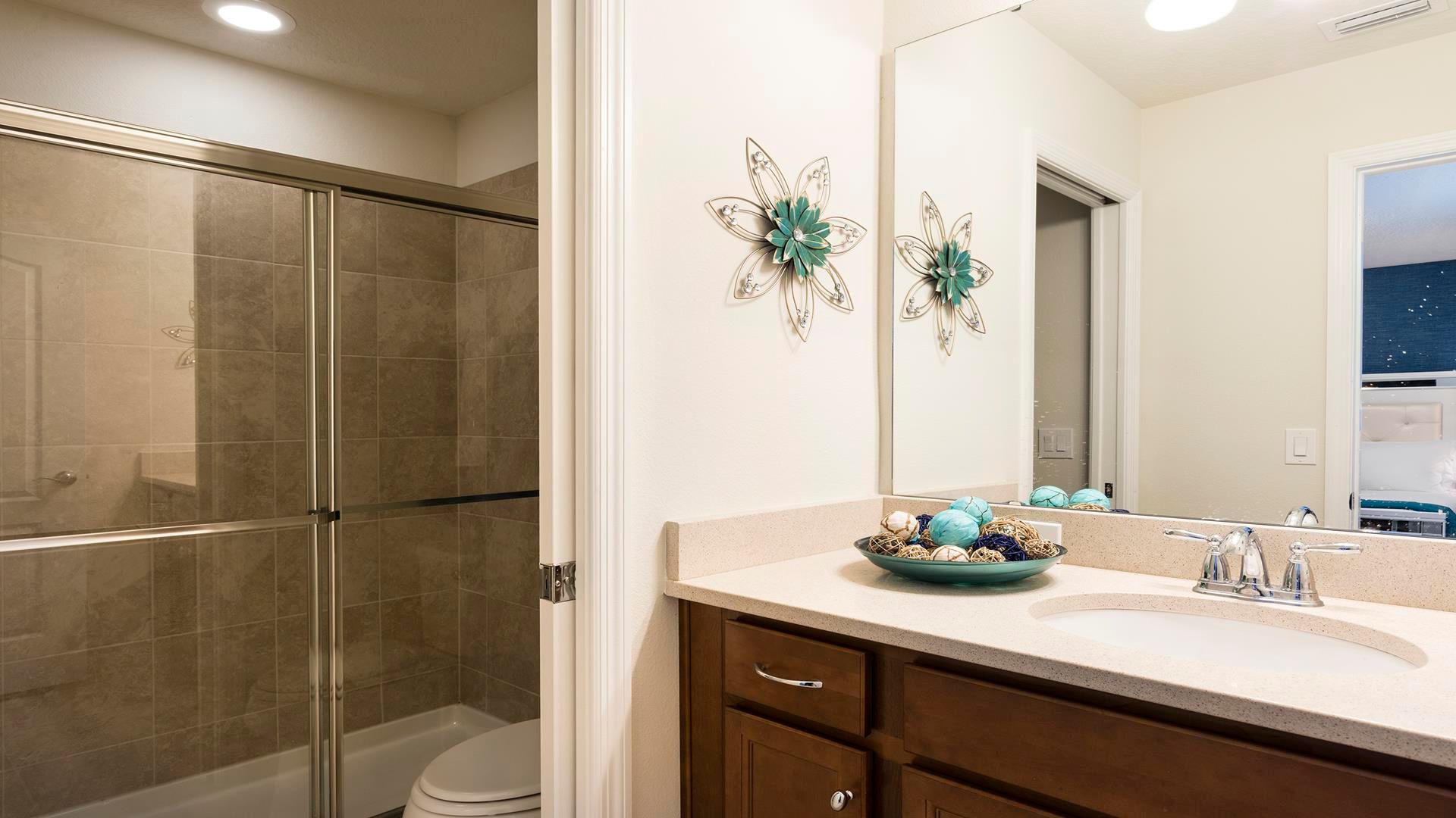 Cozy bathroom with walk-in shower, elegant decor, and warm tones!