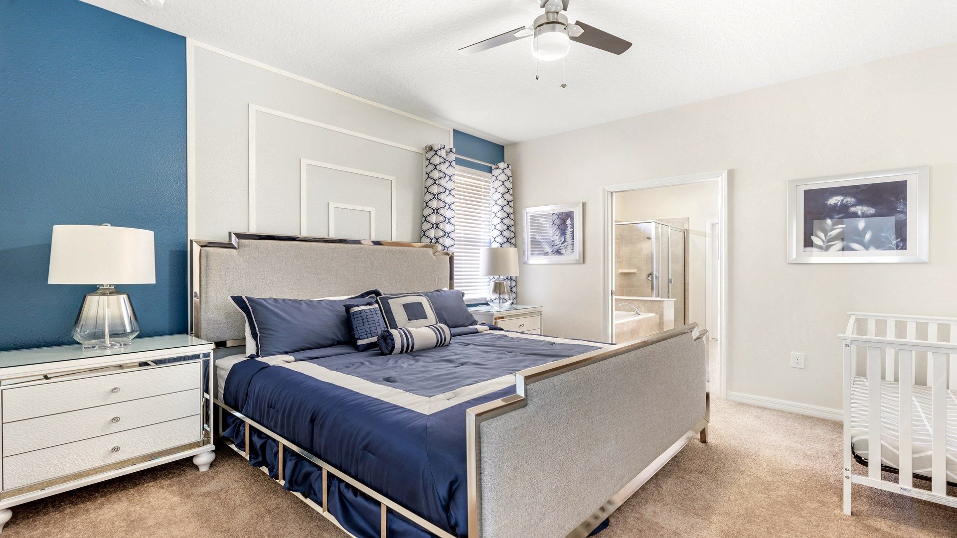 The master bedroom features a luxuriously large king bed with a crib.