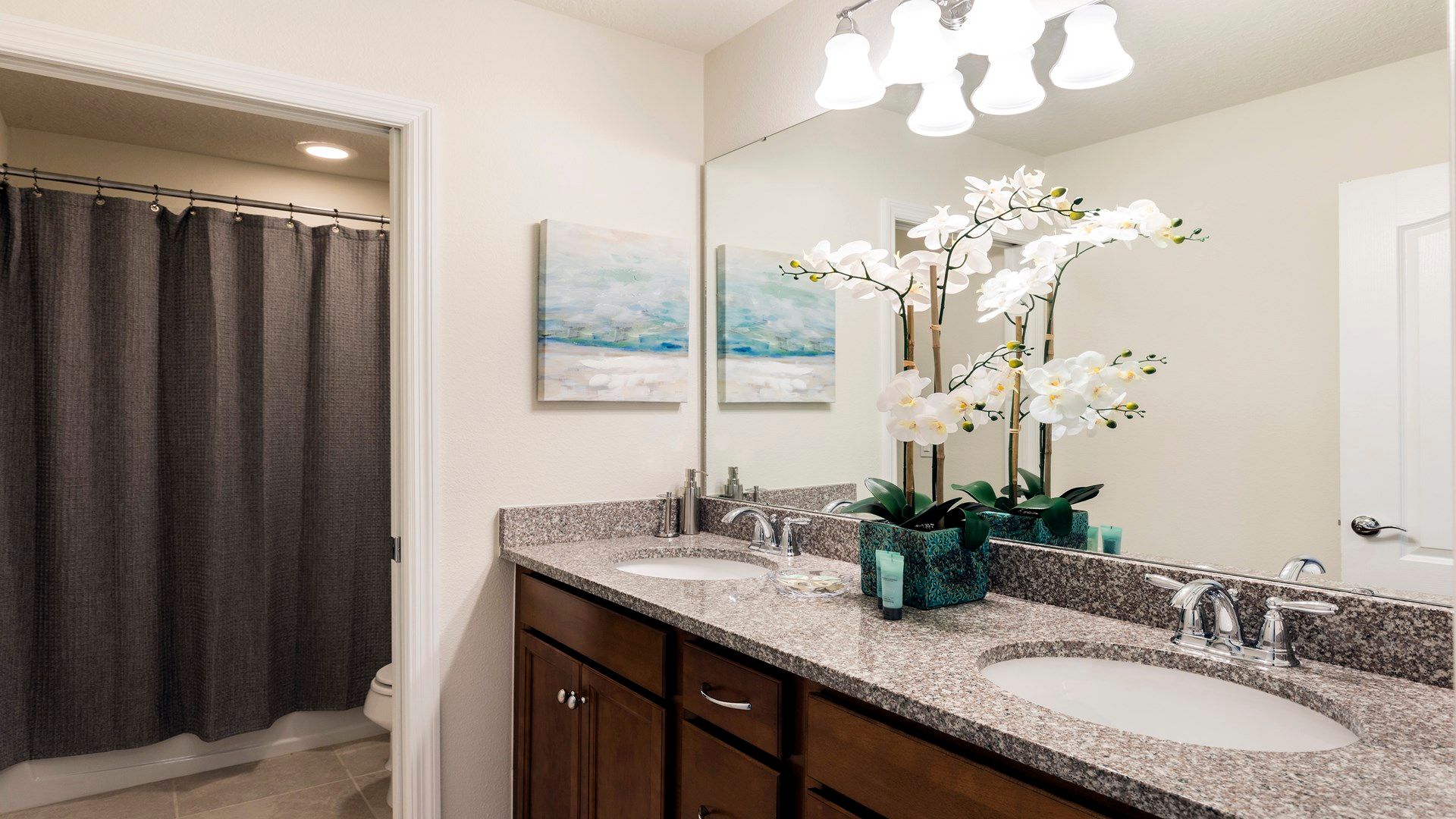 Elegant double vanity bathroom with granite counters and soft modern touches.