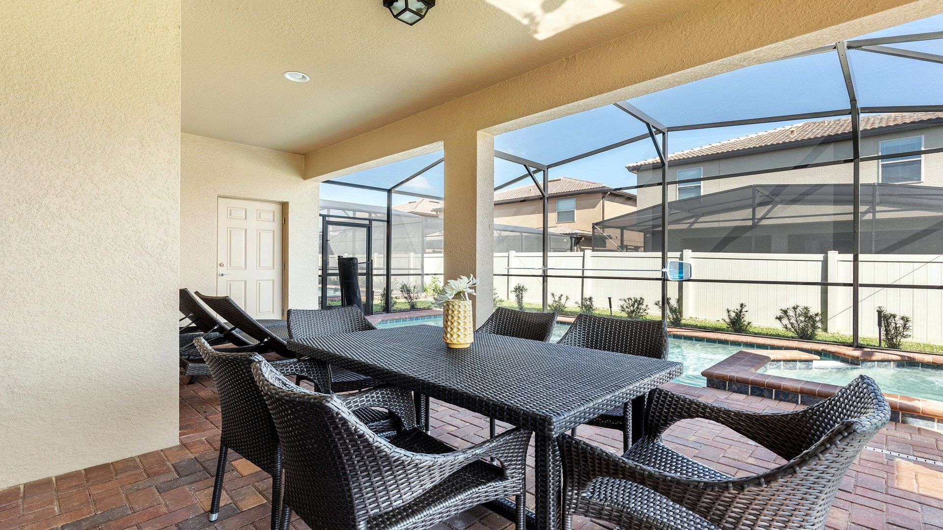Relax by the private pool in this screened patio with outdoor dining and loungers.