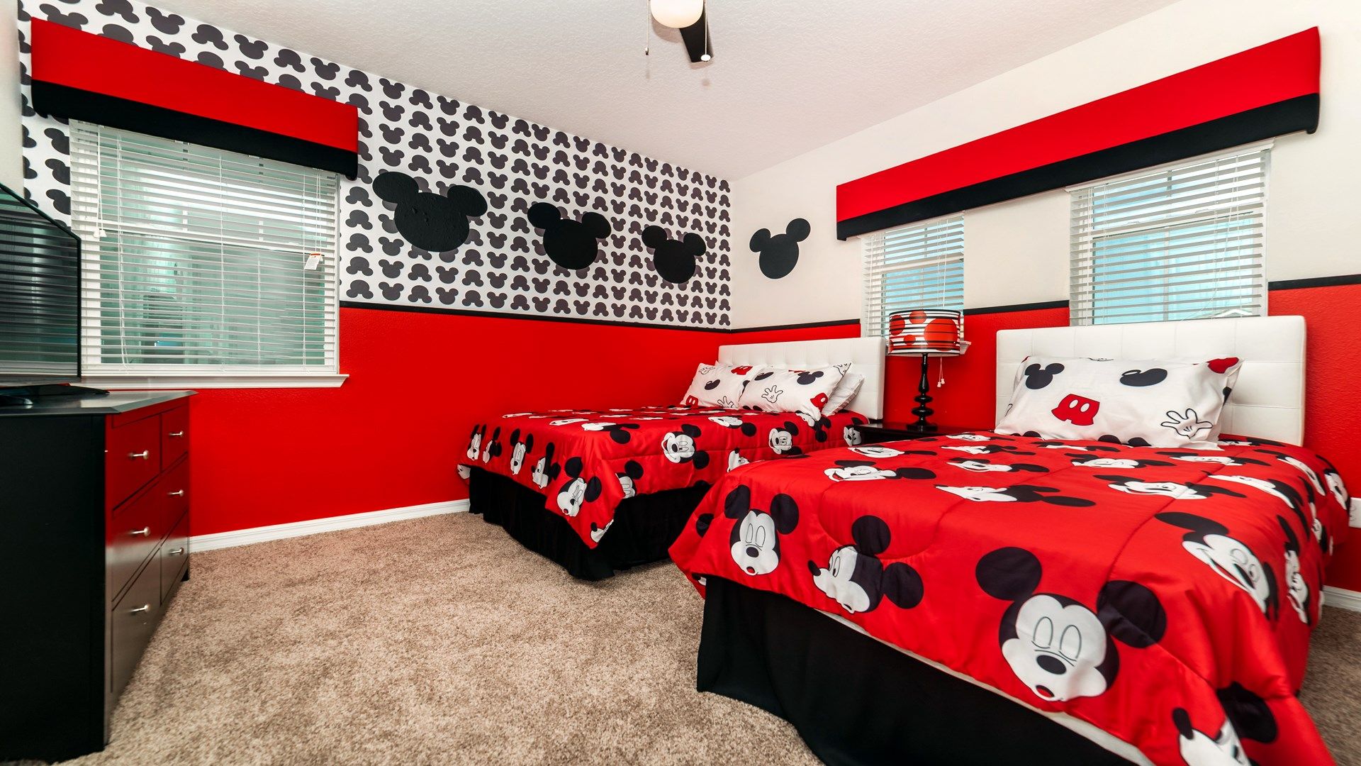 Immerse yourself in the magic of a Mickey Mouse-themed room, where the iconic character comes to life in a vibrant and enchanting setting.