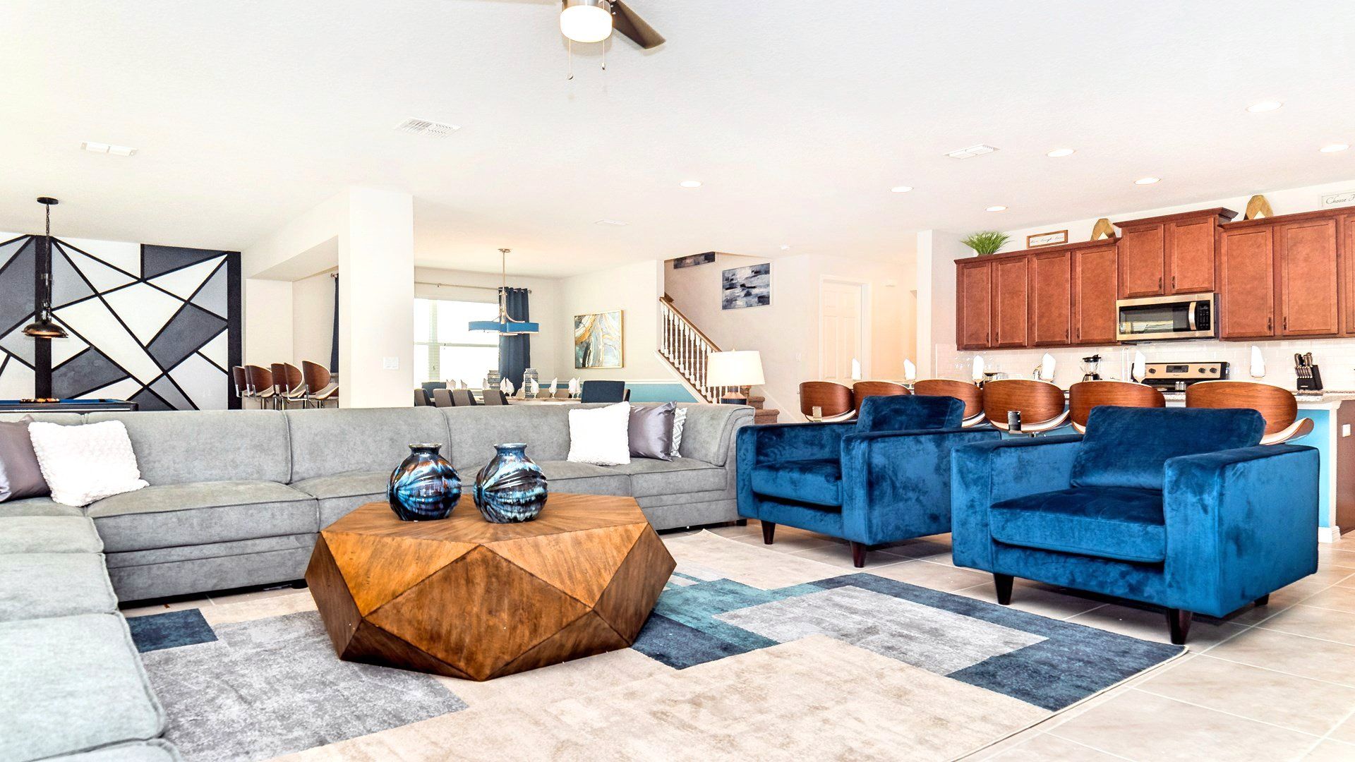 The expansive living room provides an inviting space for family gatherings, featuring a plush and comfortable sofa.