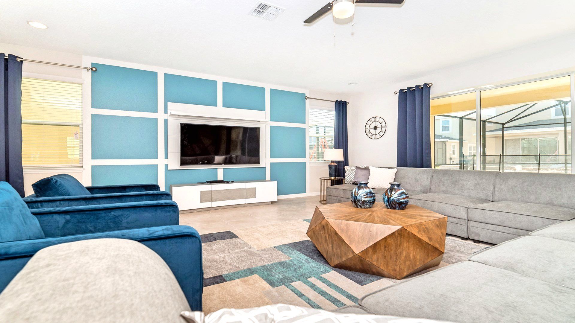 The expansive living room provides an inviting space for family gatherings, featuring a plush and comfortable sofa.