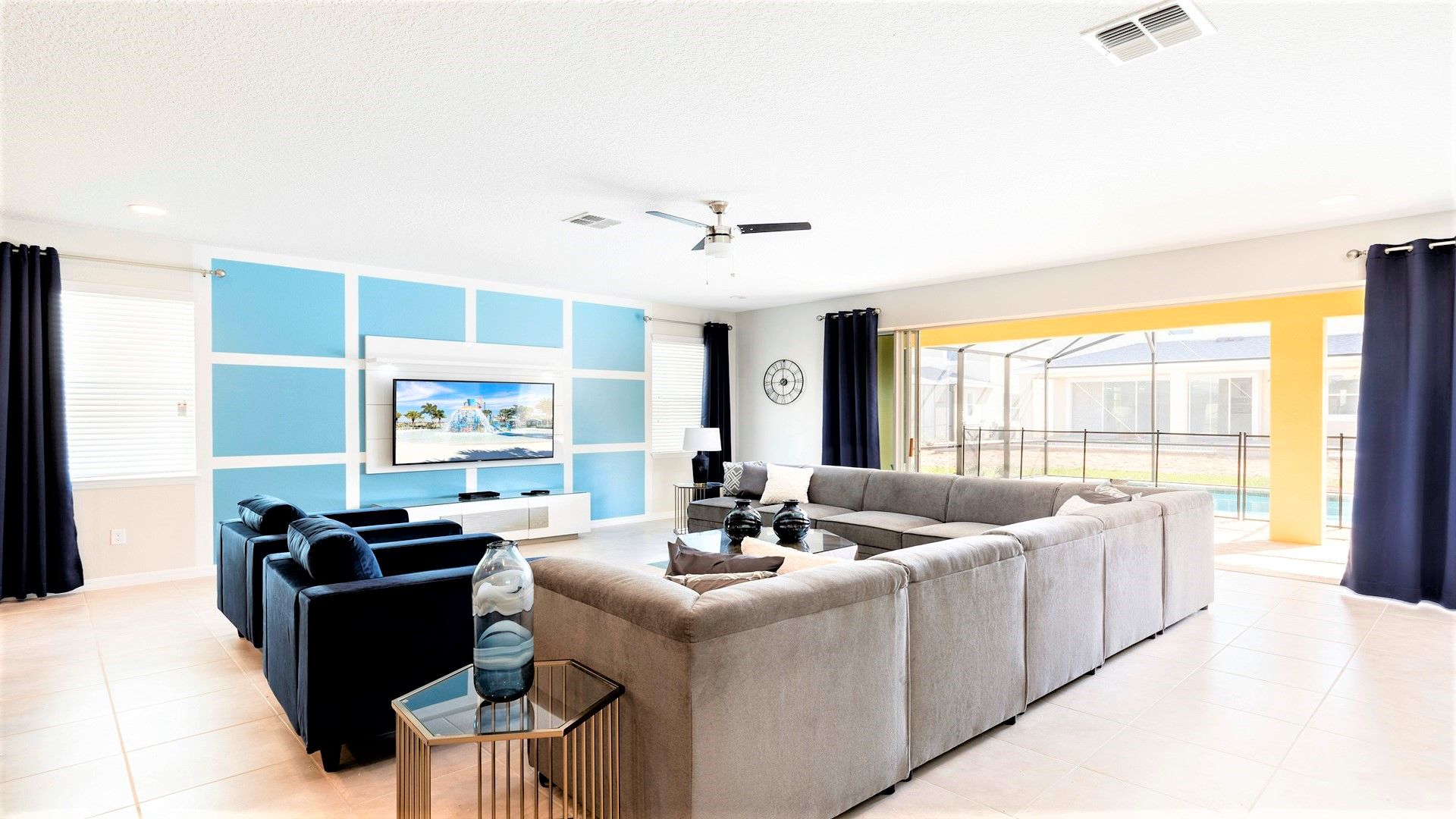 The expansive living room provides an inviting space for family gatherings, featuring a plush and comfortable sofa.