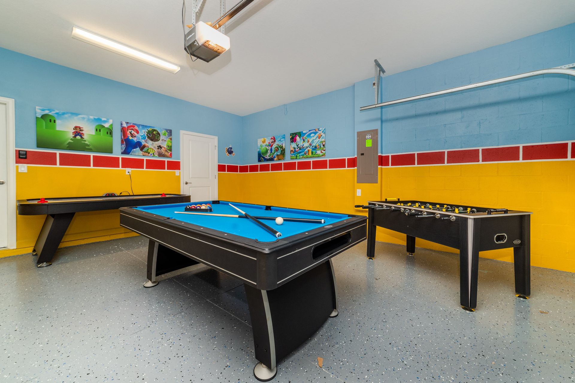 Fun game room with pool, foosball, air hockey, and colorful decor
