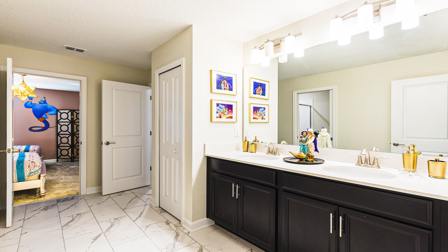 Bathroom with Aladdin-themed decor, featuring Genie artwork and a whimsical touch in the adjacent bedroom.