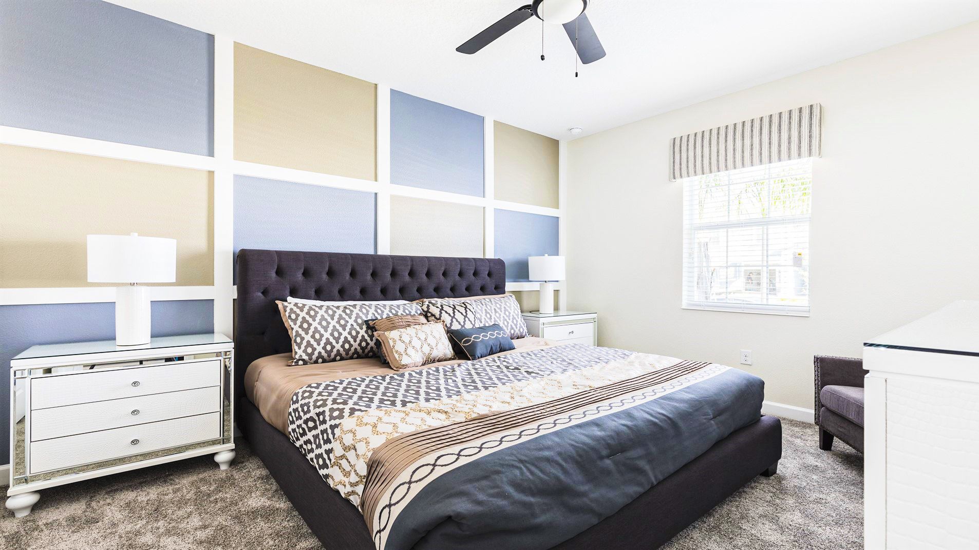 Calm and cozy bedroom with a plush bed, stylish accent wall, and plenty of natural light.
