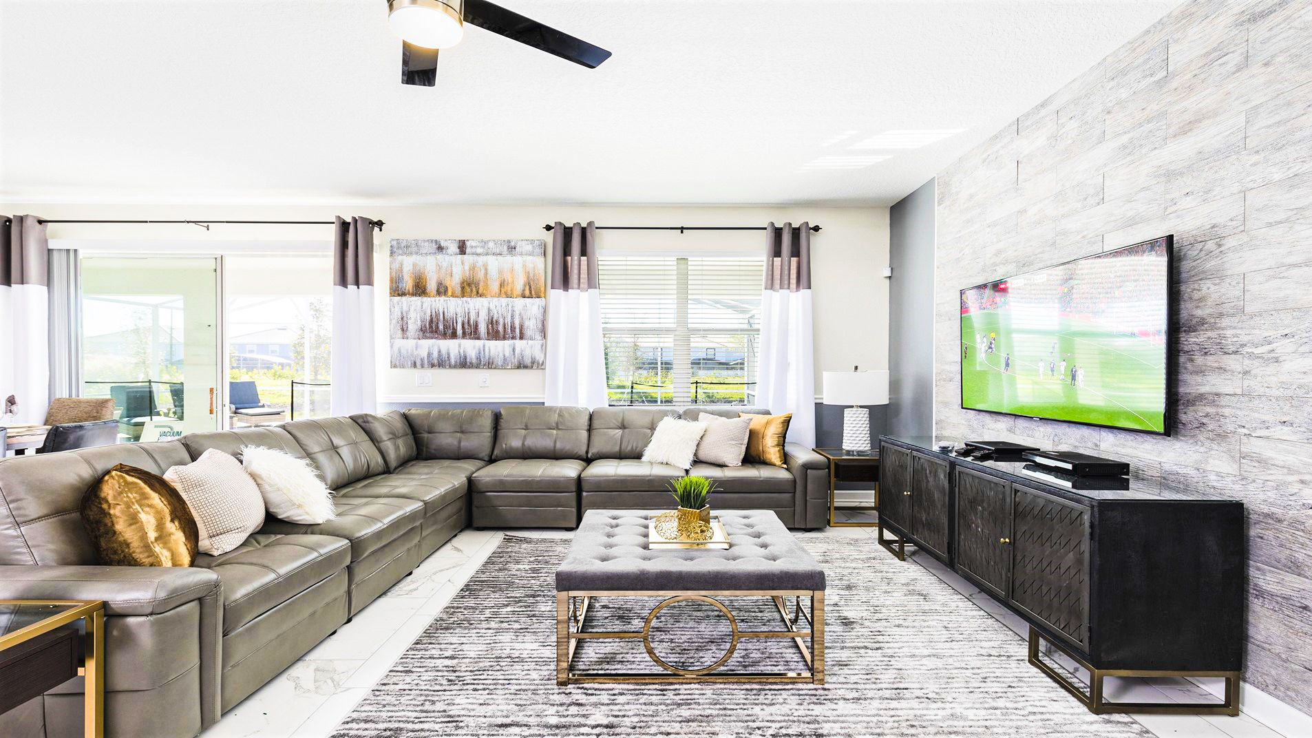 Spacious living room with plush sectional, large TV, and modern decor—ideal for cozy gatherings!
