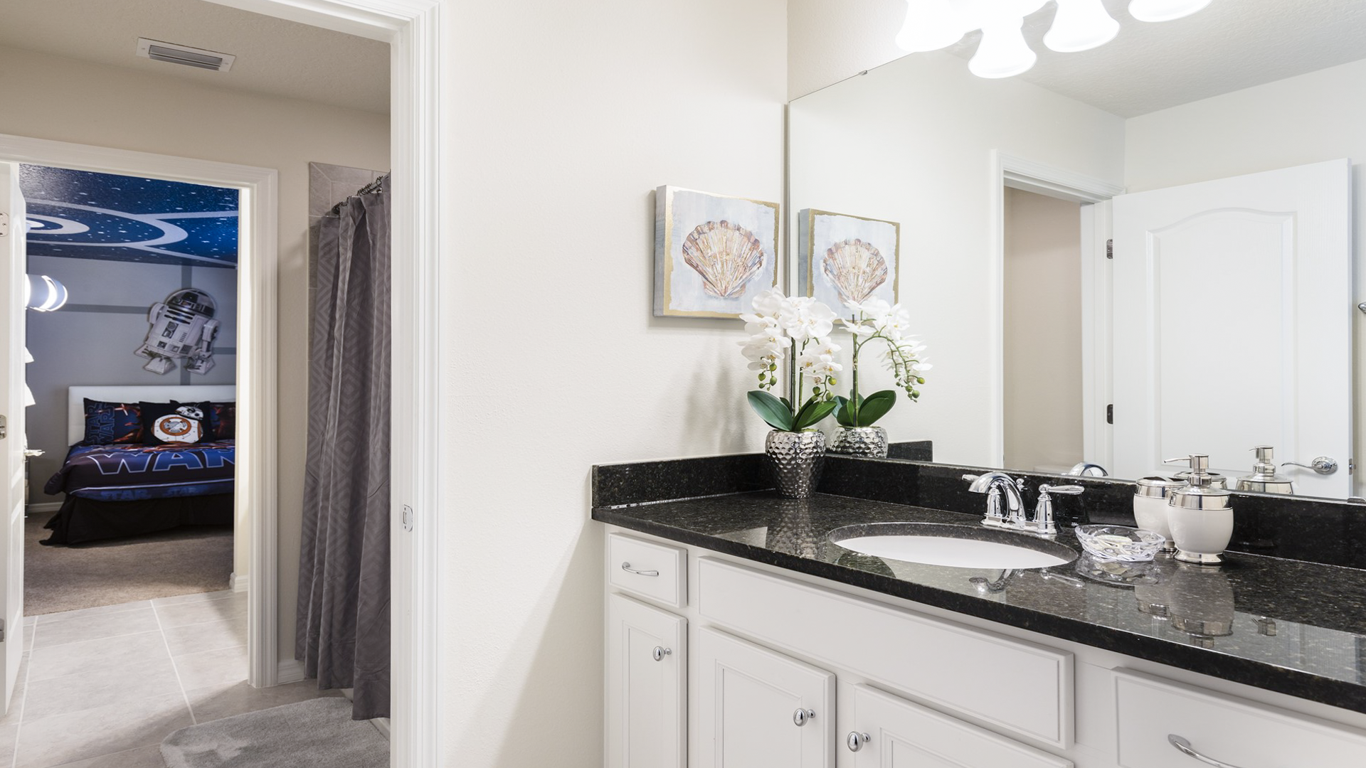 Chic bathroom with granite vanity, elegant decor, and access to the Star Wars-themed bedroom.