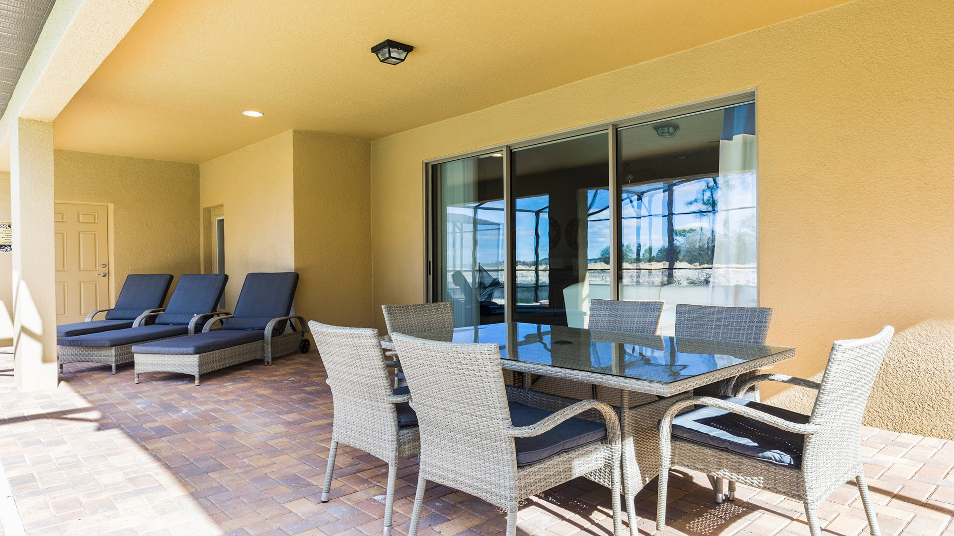 Enjoy outdoor comfort with seating by the pool.