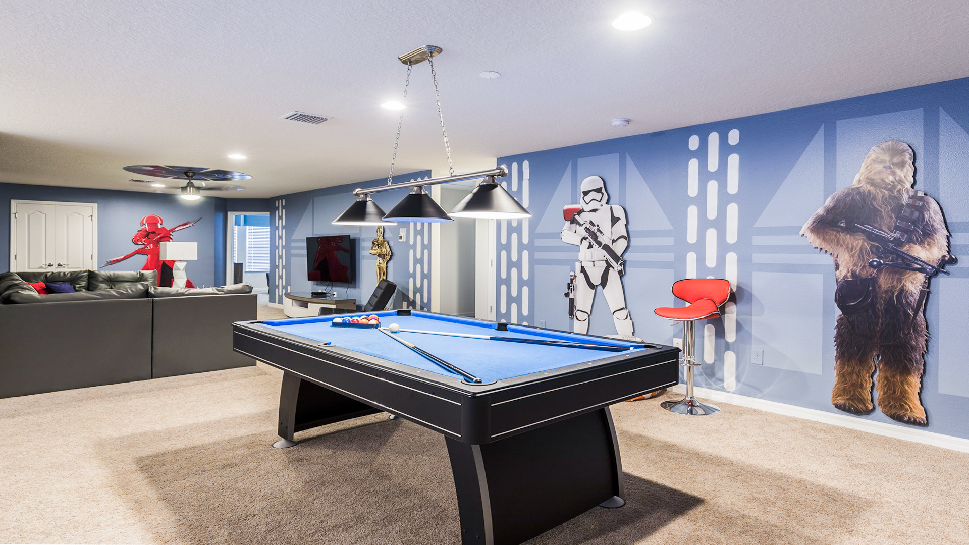 Ultimate Star Wars game room with pool table, themed decor, life-size figures, and comfy seating.