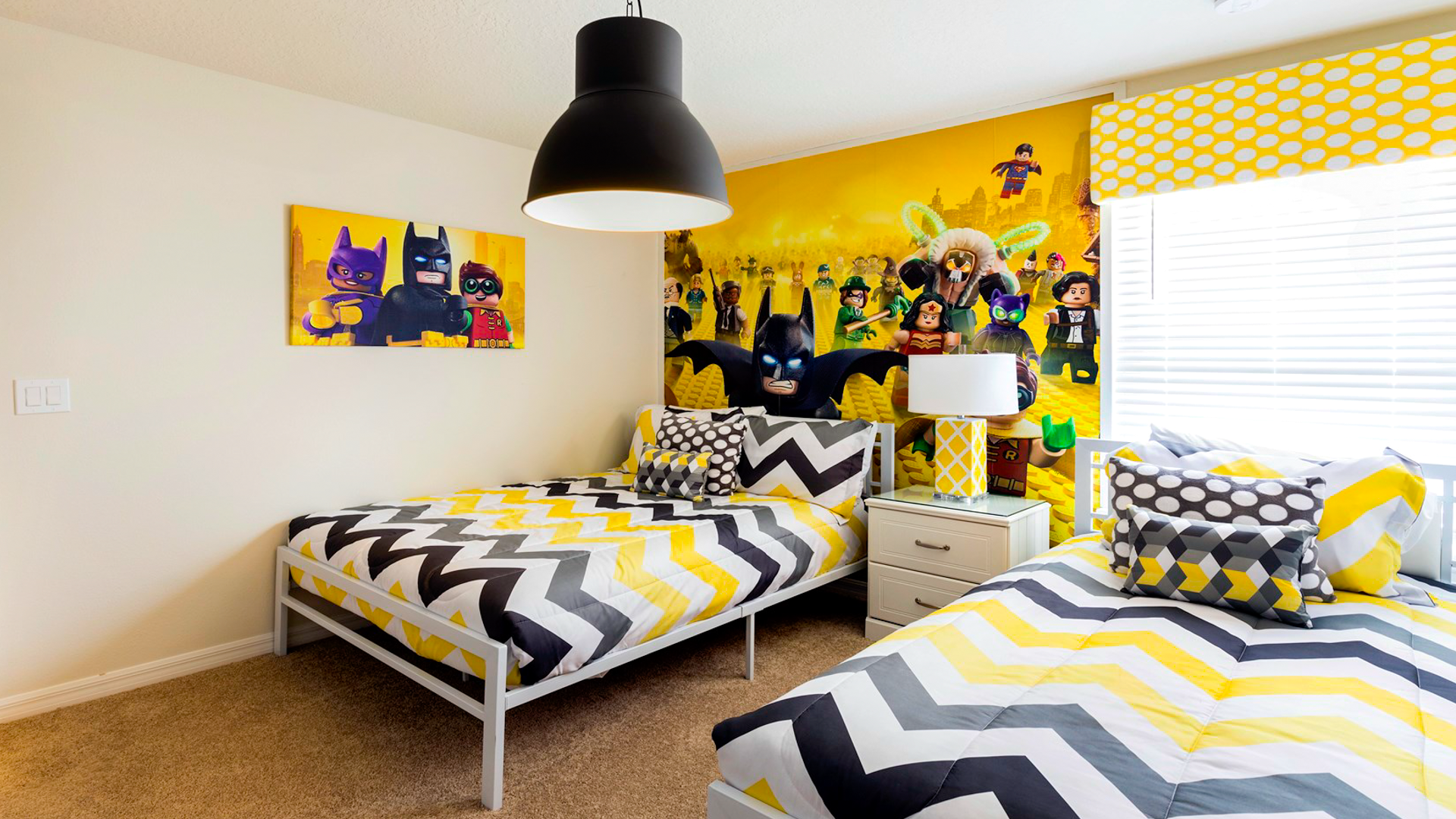 Fun, vibrant kids' room with bold colors, twin beds, and playful themed decor.