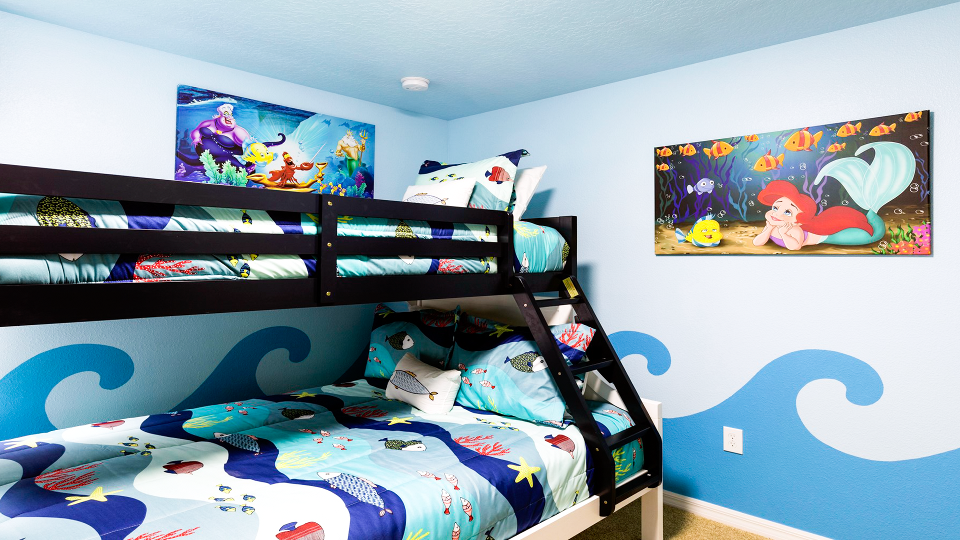 Magical mermaid-themed room with ocean-inspired bunk beds and colorful sea decor.