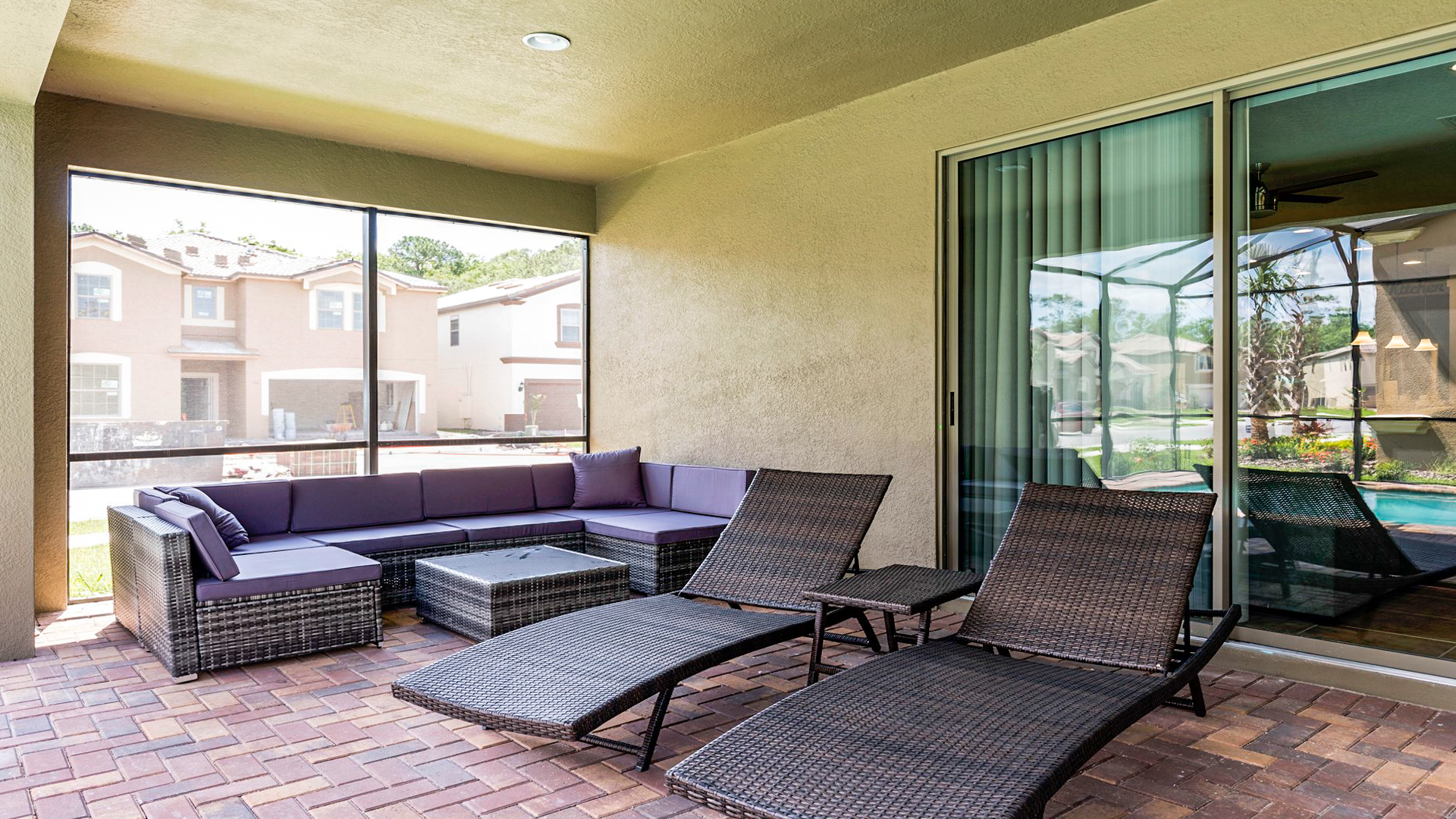 Relax in the shaded outdoor lounge with comfy seating and poolside views.