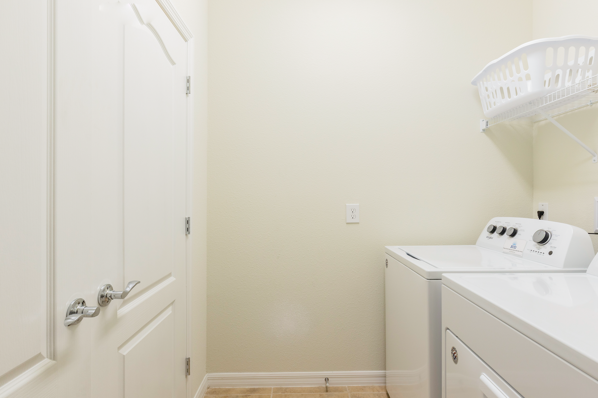 Bright laundry room with washer, dryer, and ample space for your convenience.