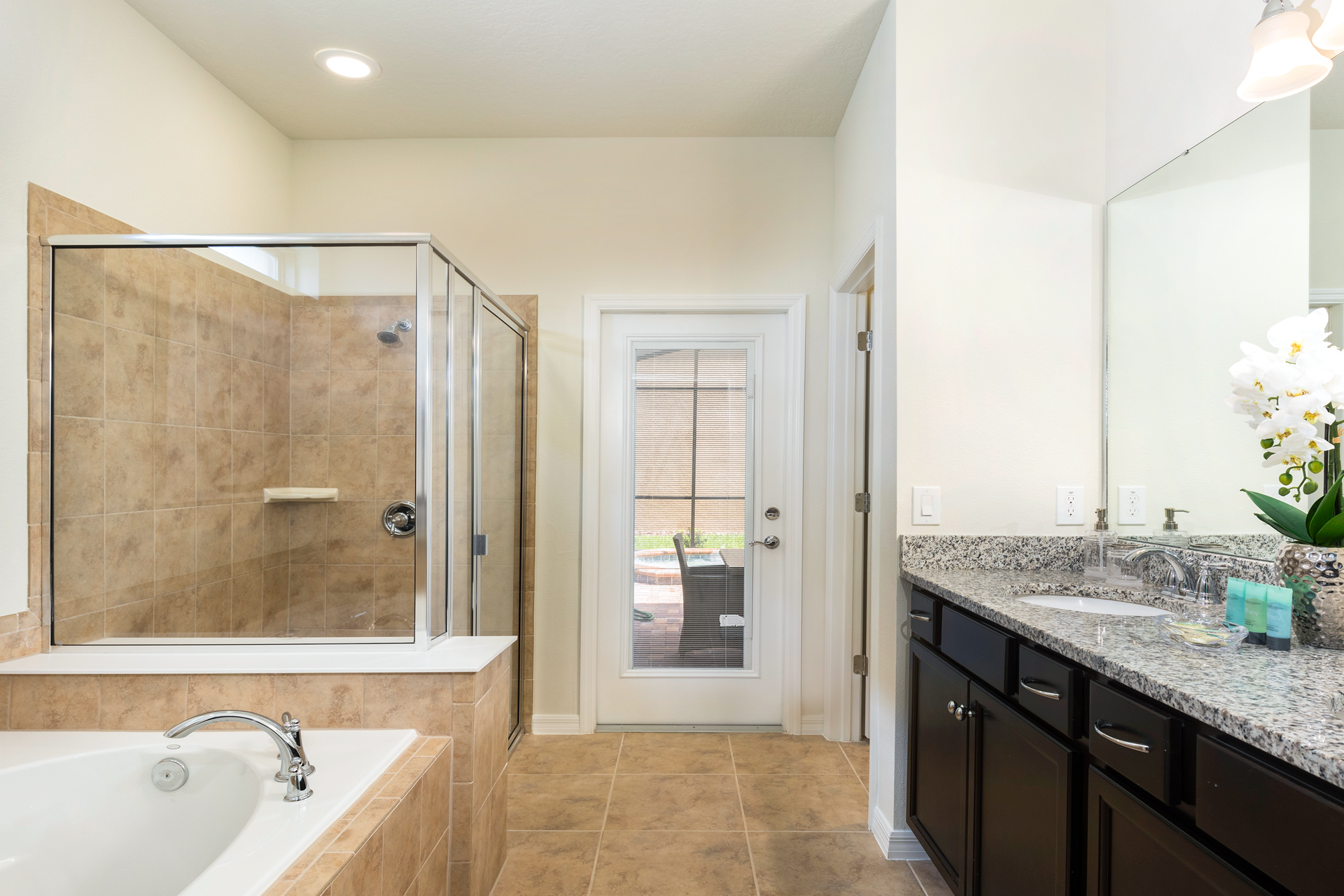 Luxurious master bath with walk-in shower, soaking tub, and elegant double vanity.
