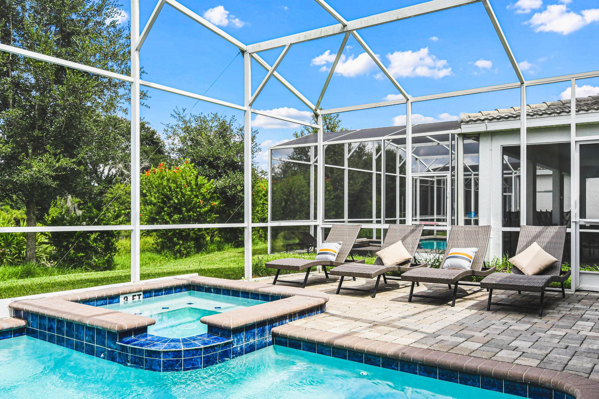 Outdoor pool area with a screened enclosure, offering a private and protected space for relaxation and enjoyment