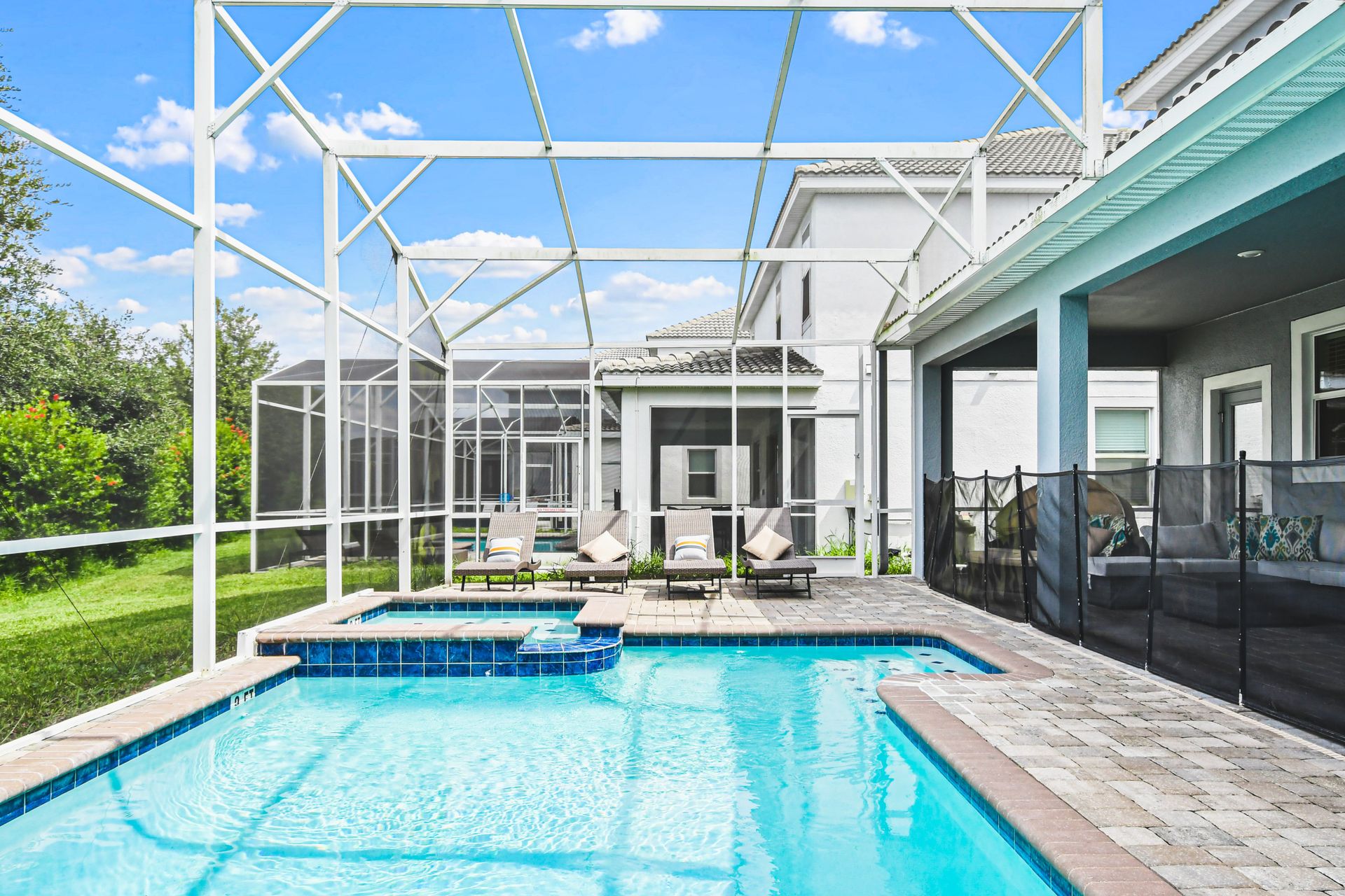 Outdoor pool area with a screened enclosure, offering a private and protected space for relaxation and enjoyment