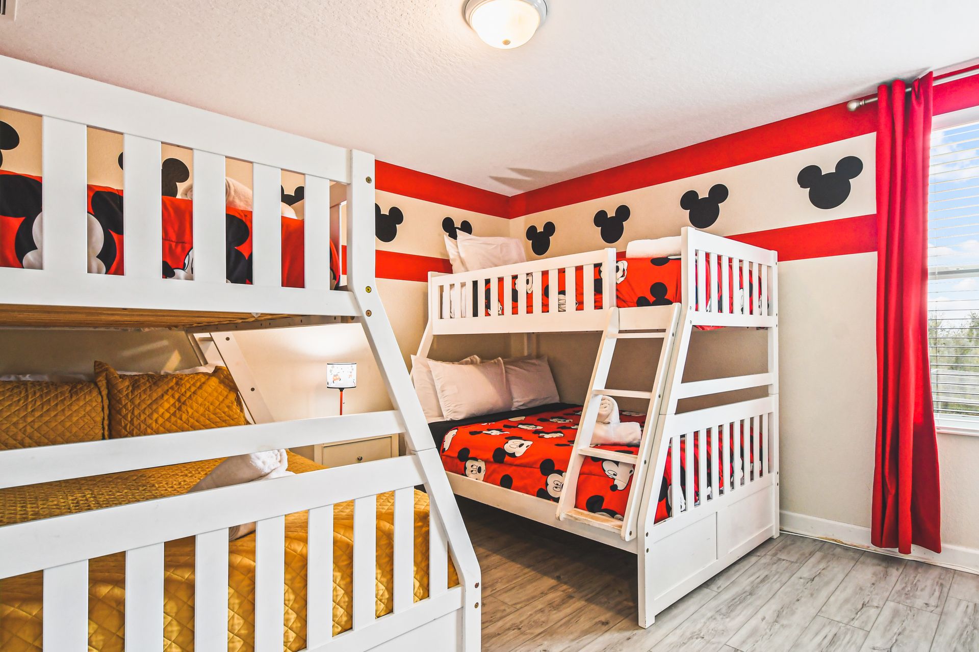 Mickey Mouse-themed bedroom with two bunk beds for playful nights.