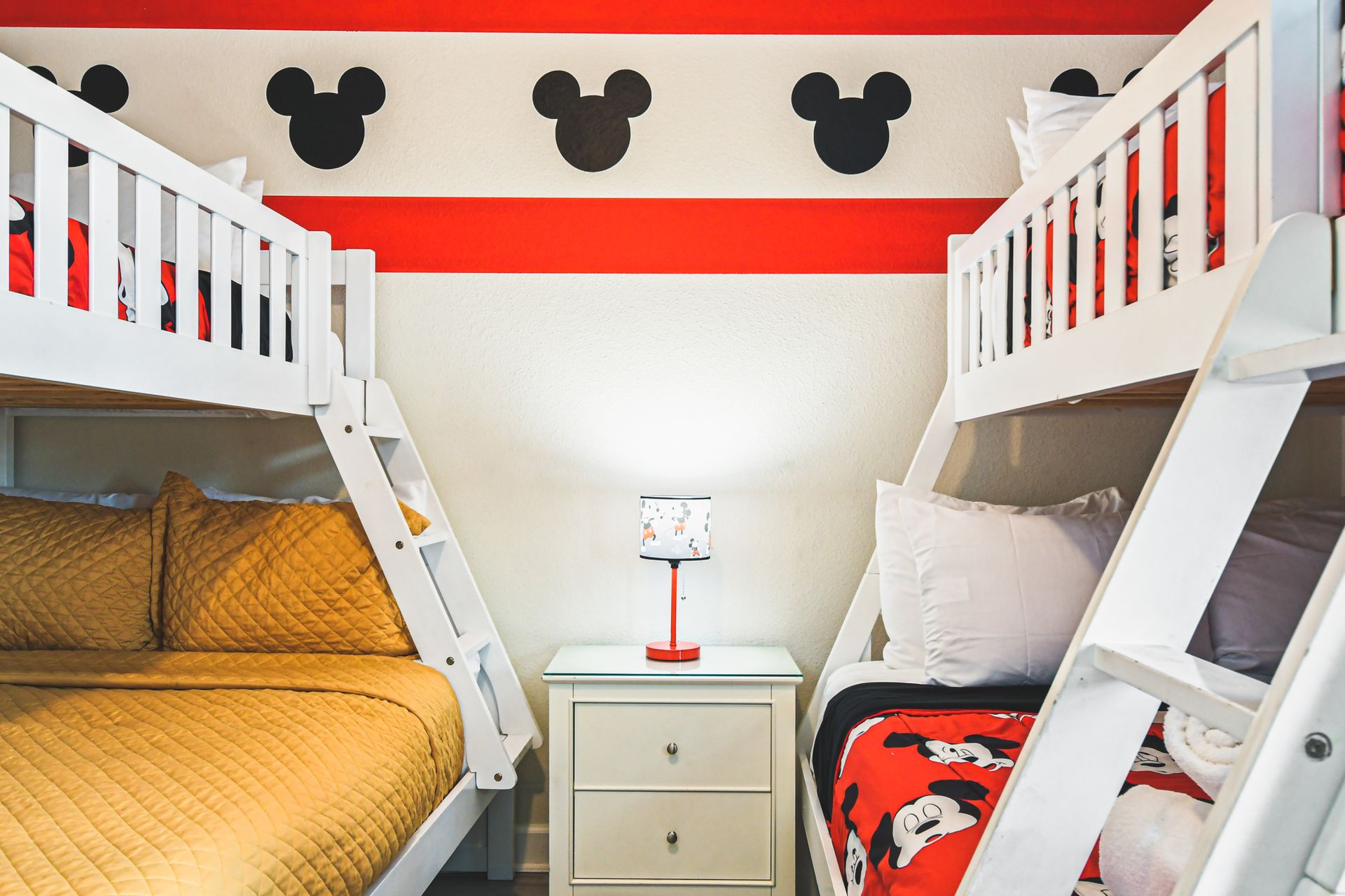 Mickey Mouse-themed bedroom with two bunk beds for playful nights.