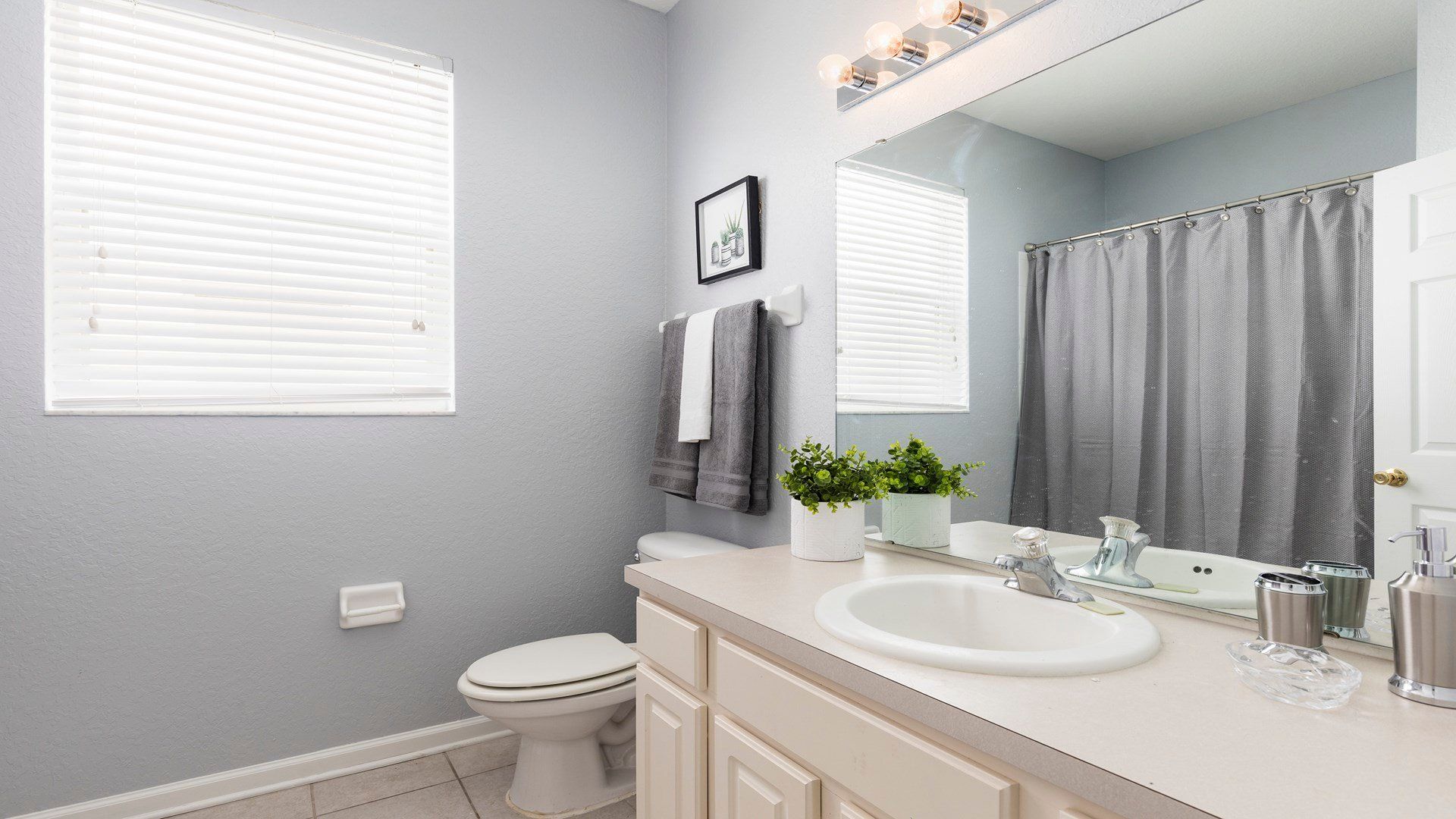 Modern and bright bathroom with stylish decor, soft towels, and a relaxing vibe!