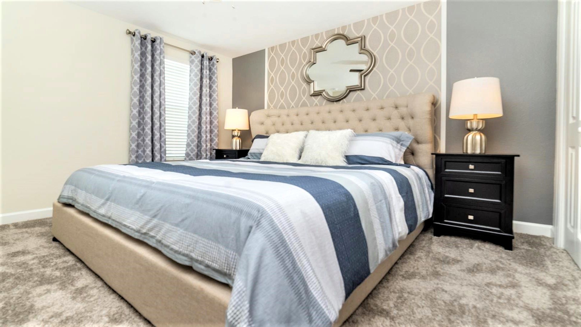 Cozy bedroom with stylish decor, plush bedding, and soft lighting for relaxation.