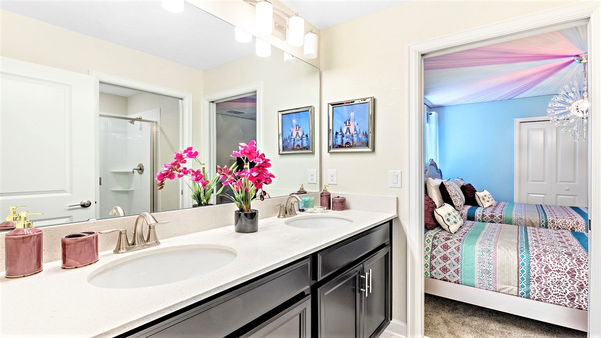 Elegant bathroom with dual sinks, glass shower, and chic floral accents.
