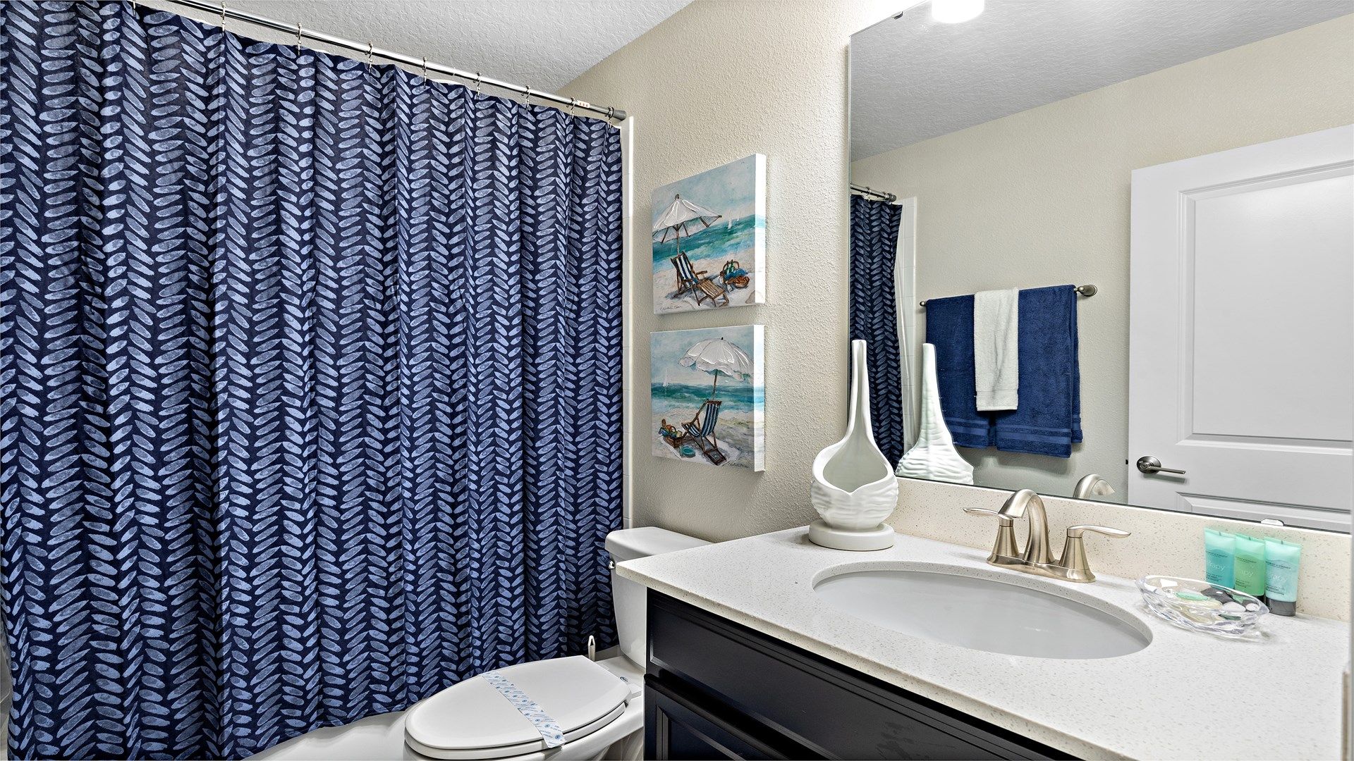 Elegant bathroom with dual sinks, glass shower, and chic floral accents.