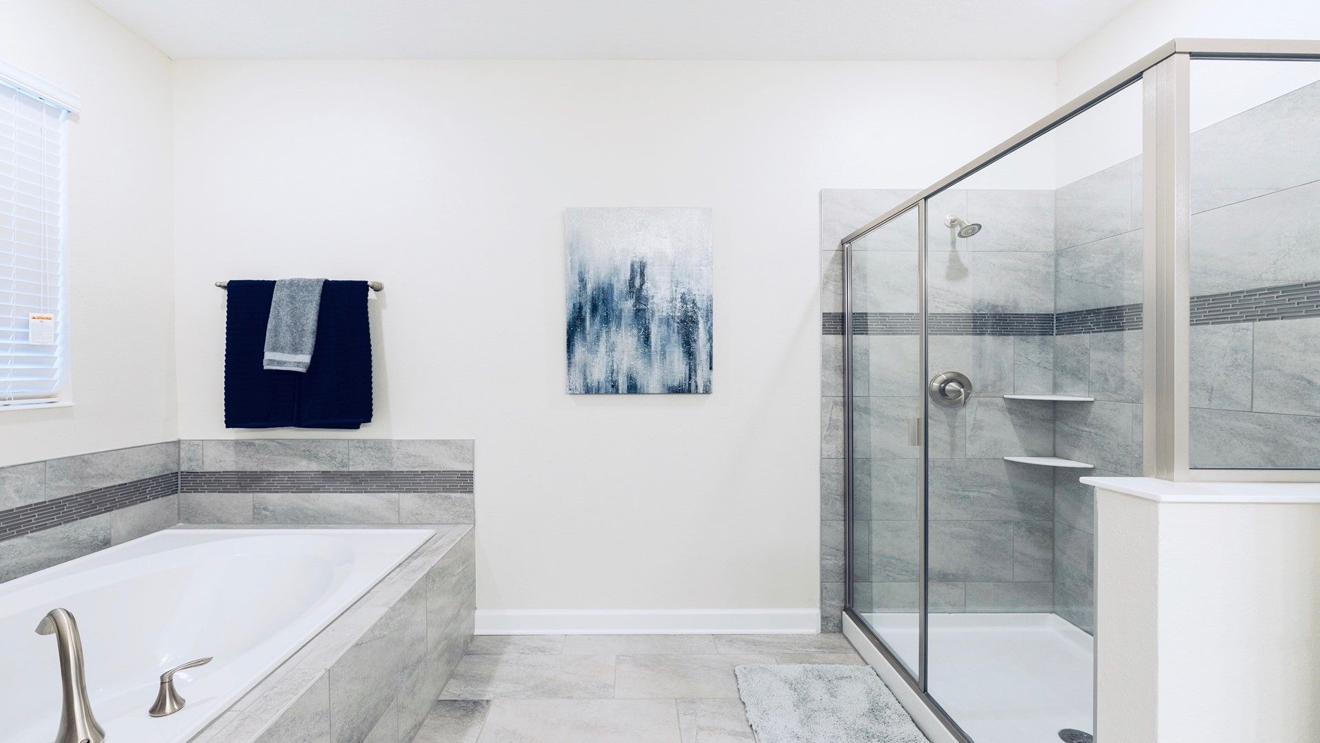 Elegant bathroom with soaking tub, glass shower, and modern accents.