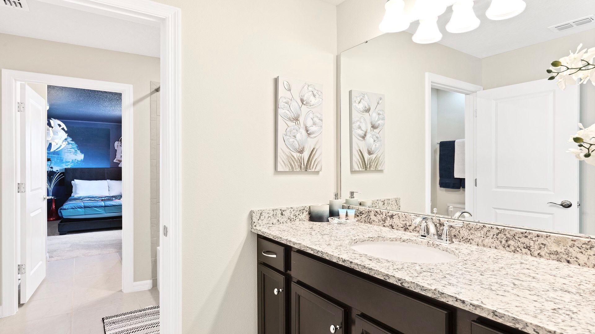Modern bathroom with granite countertops, sleek fixtures, and neutral decor.