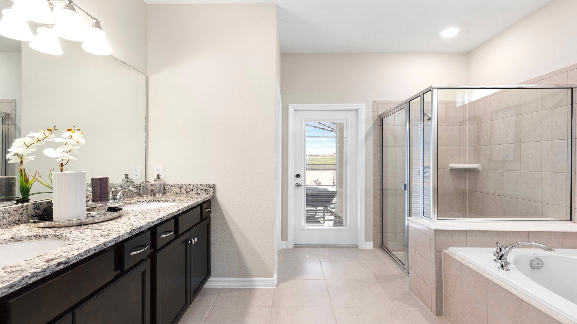 Spacious bathroom with granite counters, a glass shower, and a soaking tub.