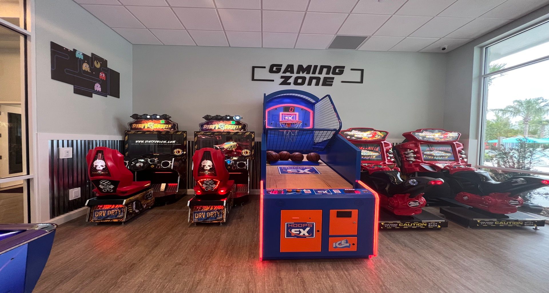 Exciting gaming zone featuring basketball hoops, racing simulators, and arcade fun!