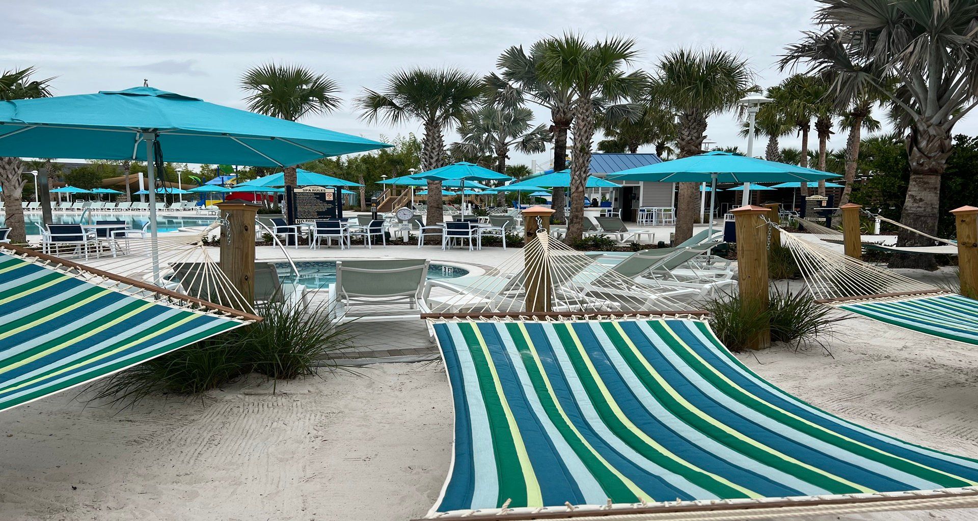 Relax in vibrant hammocks under swaying palms, steps away from the sparkling pool.