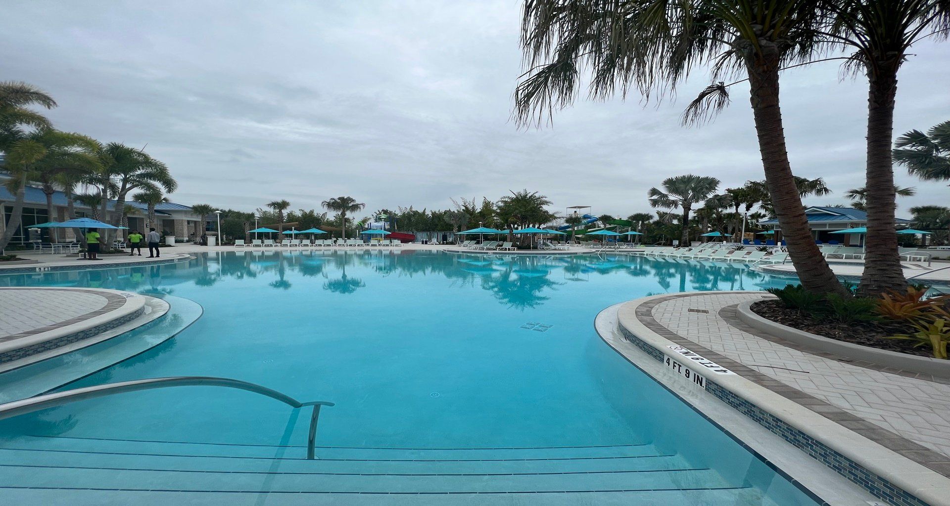 Dive into paradise with this expansive resort pool, framed by palm trees and cabanas.
