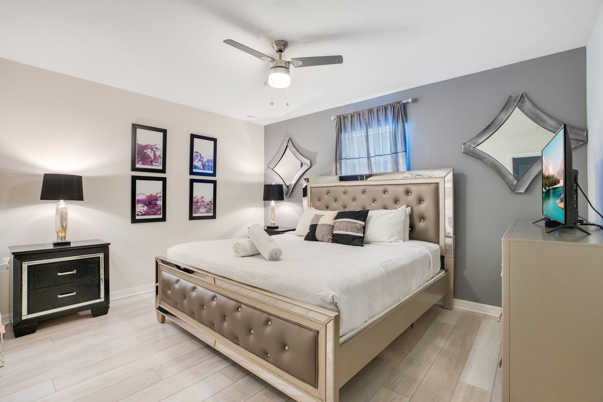 Elegant bedroom with tufted furniture, modern decor, and soft ambient lighting.