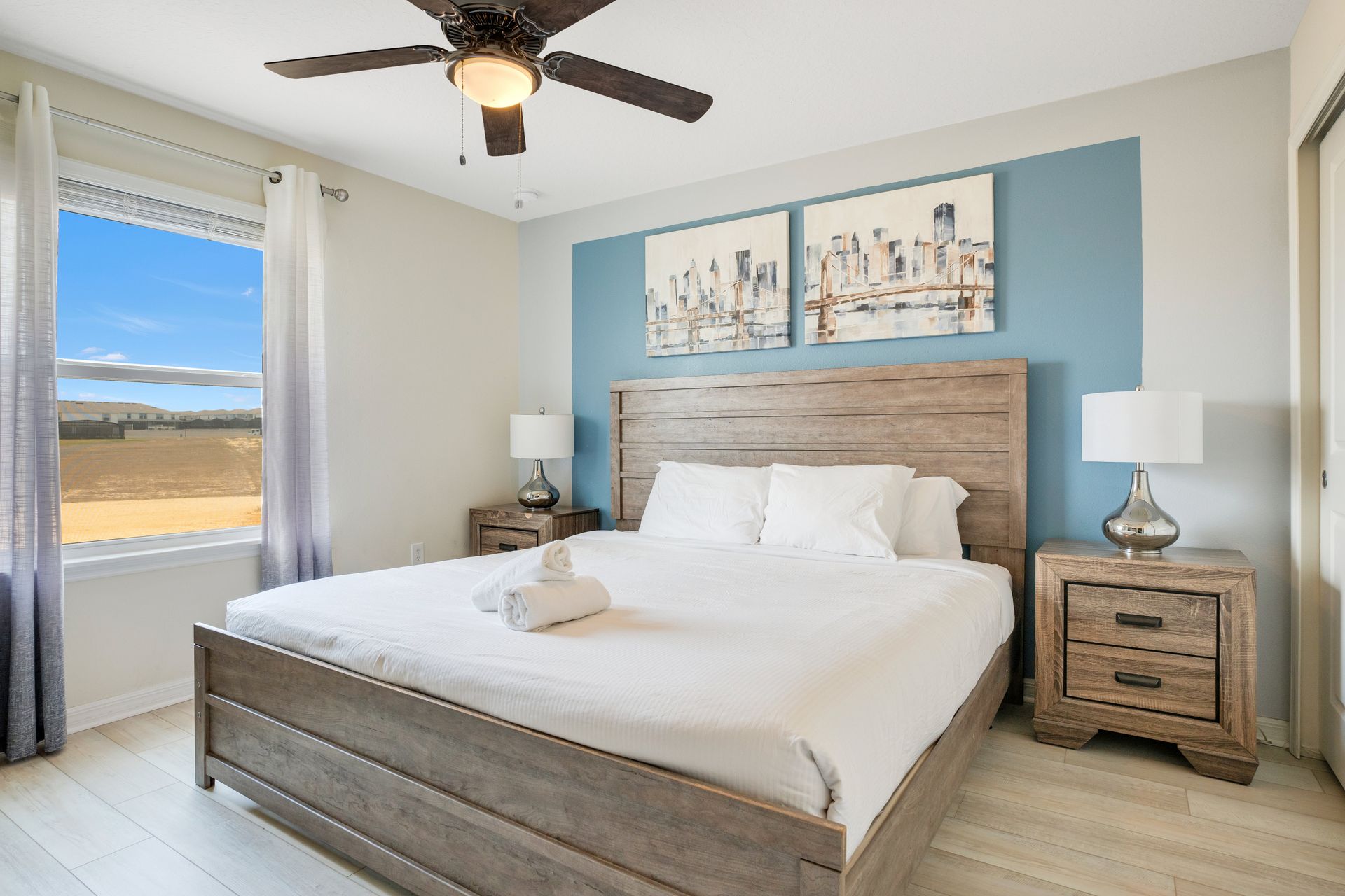 Cozy bedroom with rustic wooden furniture, soft lighting, and a serene view.